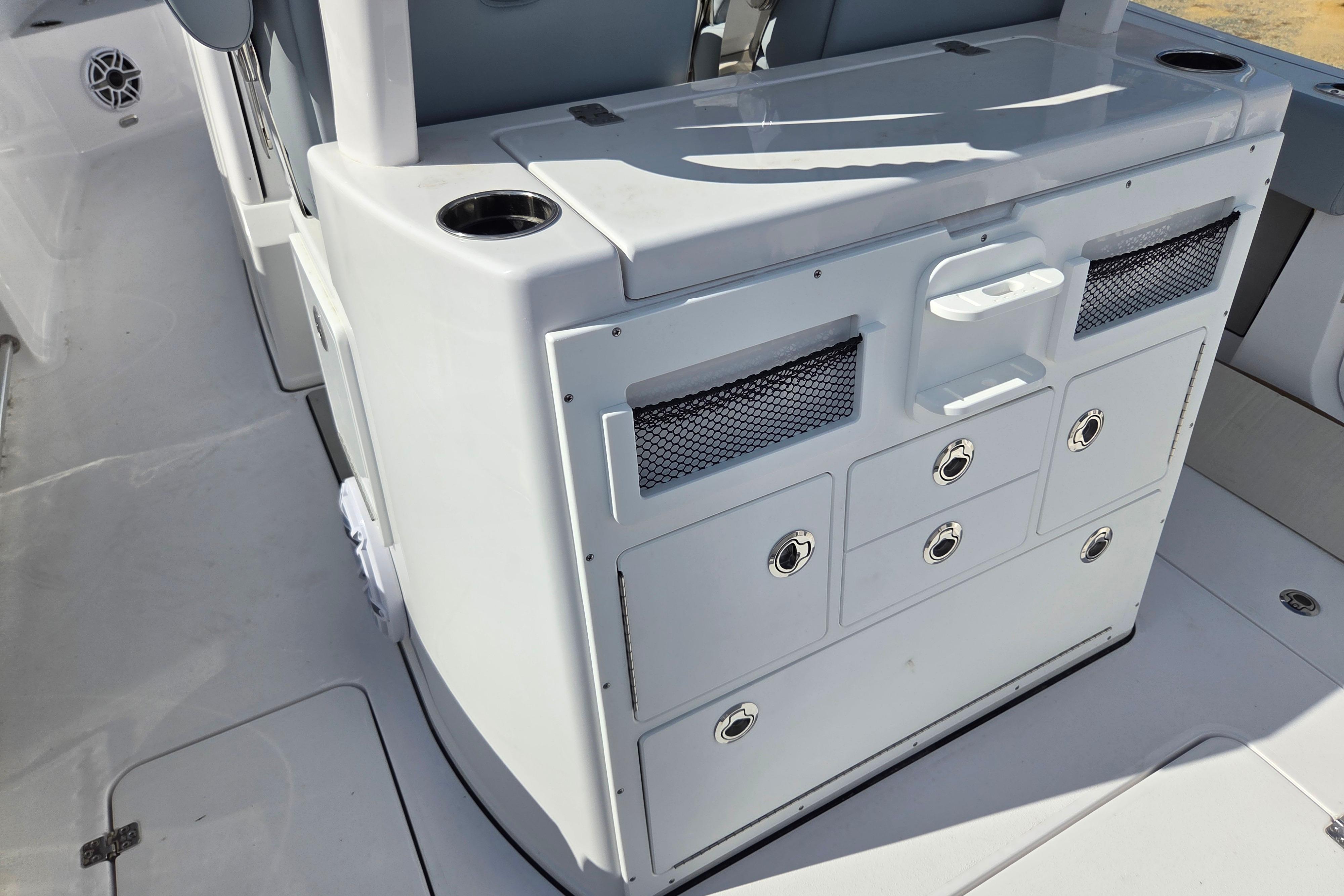 2026 Sportsman Open 282 Center Console boat interior with storage compartments and cup holders.