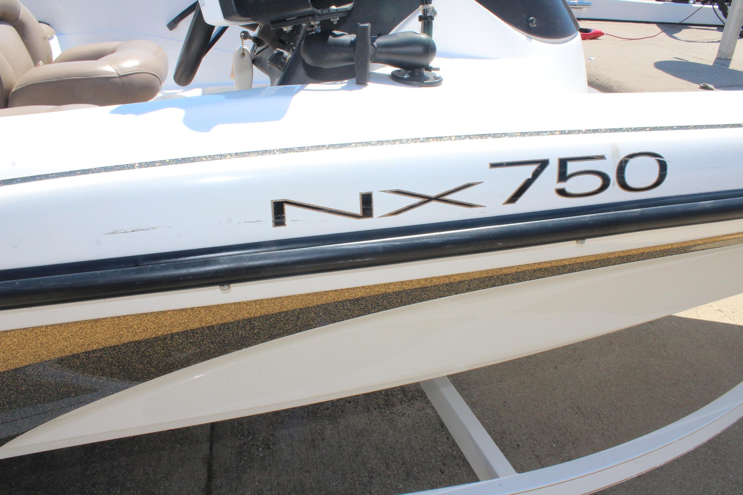 2003 Nitro NX 750 SC boat side view with steering wheel and seating.