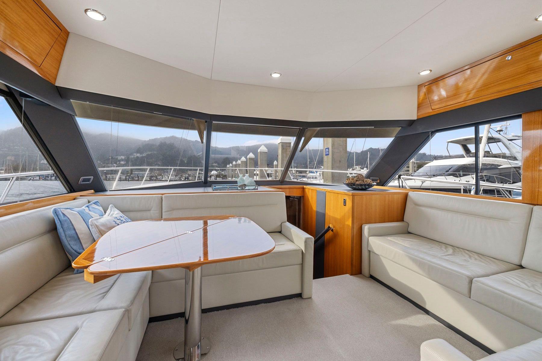 Luxurious interior of 2014 Maritimo M50 yacht with panoramic windows and elegant seating area.