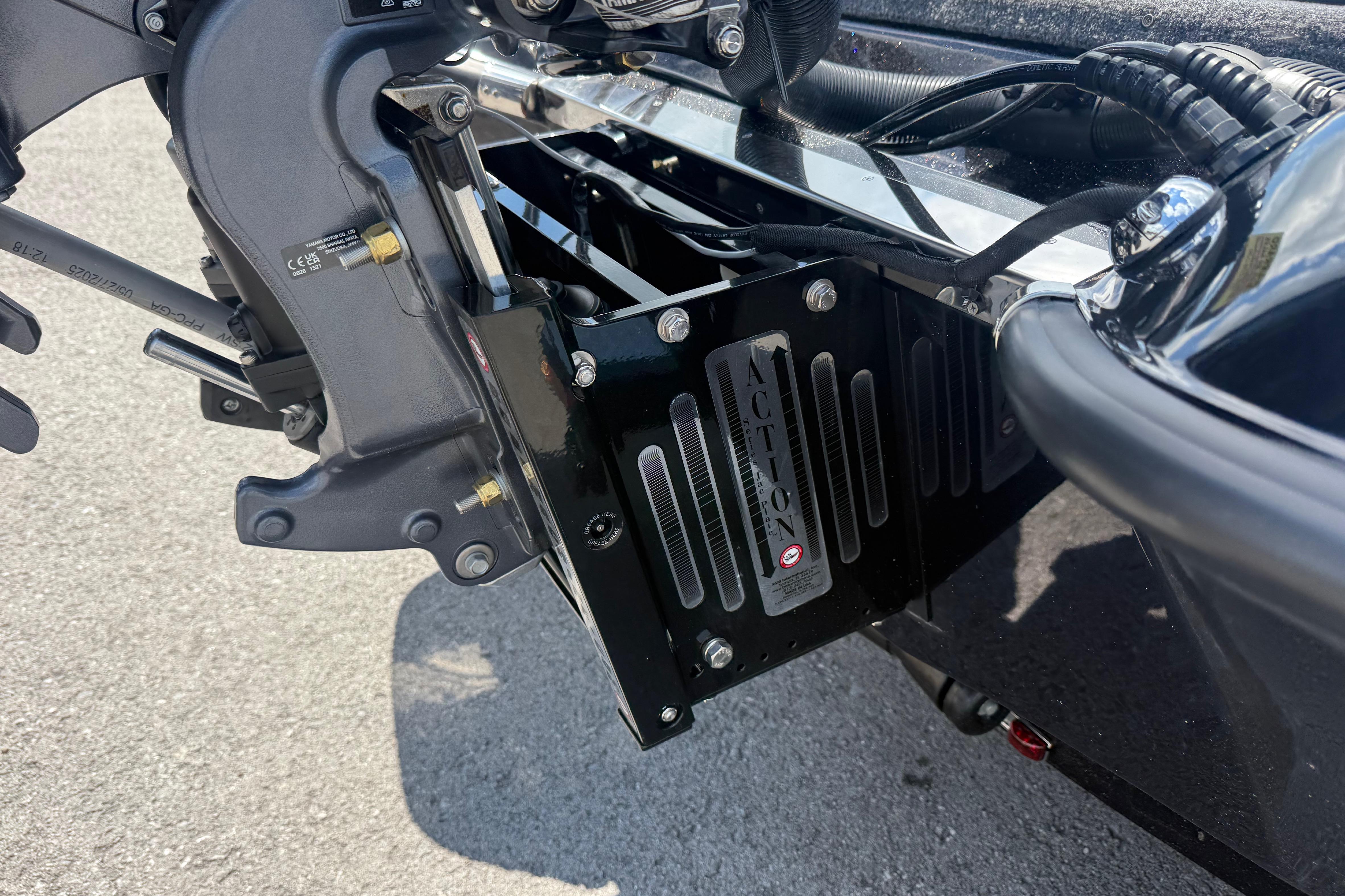 Close-up of 2027 Phoenix 721 ZXL boat motor mount on pavement.