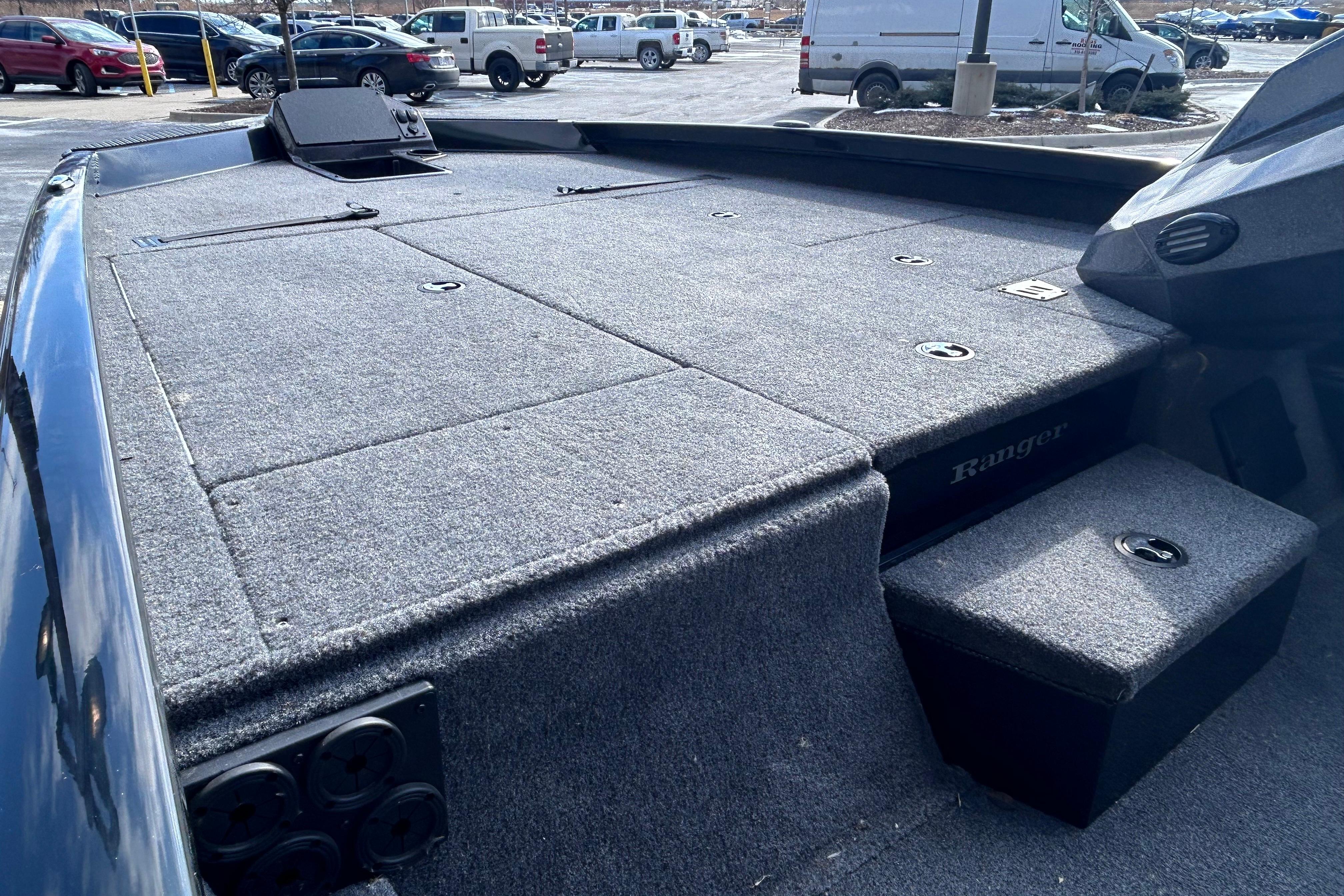2025 Ranger RT198P boat deck with carpeted surface in a parking lot.