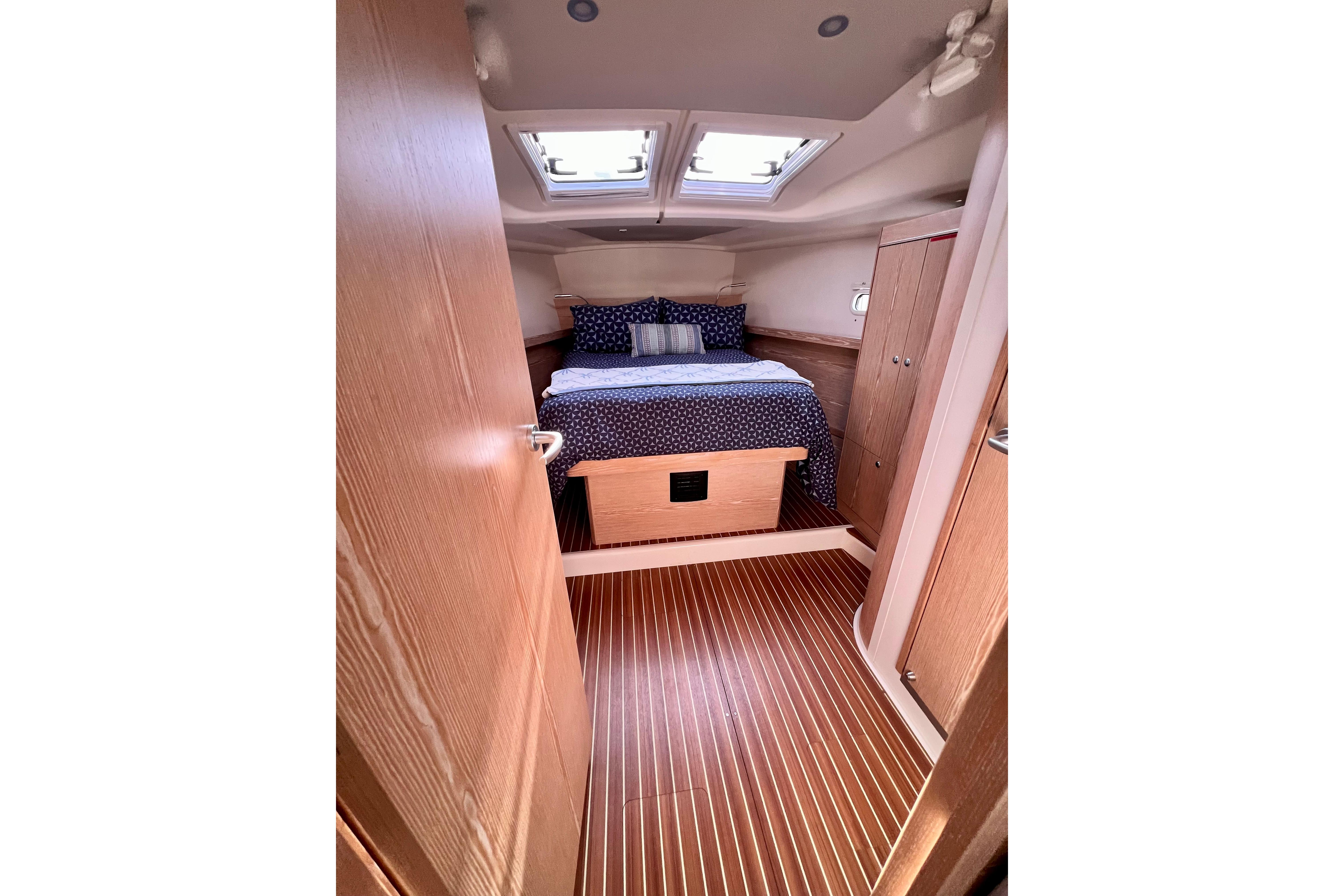 Cozy cabin interior of 2016 Hanse 455 yacht with skylights and wooden flooring.