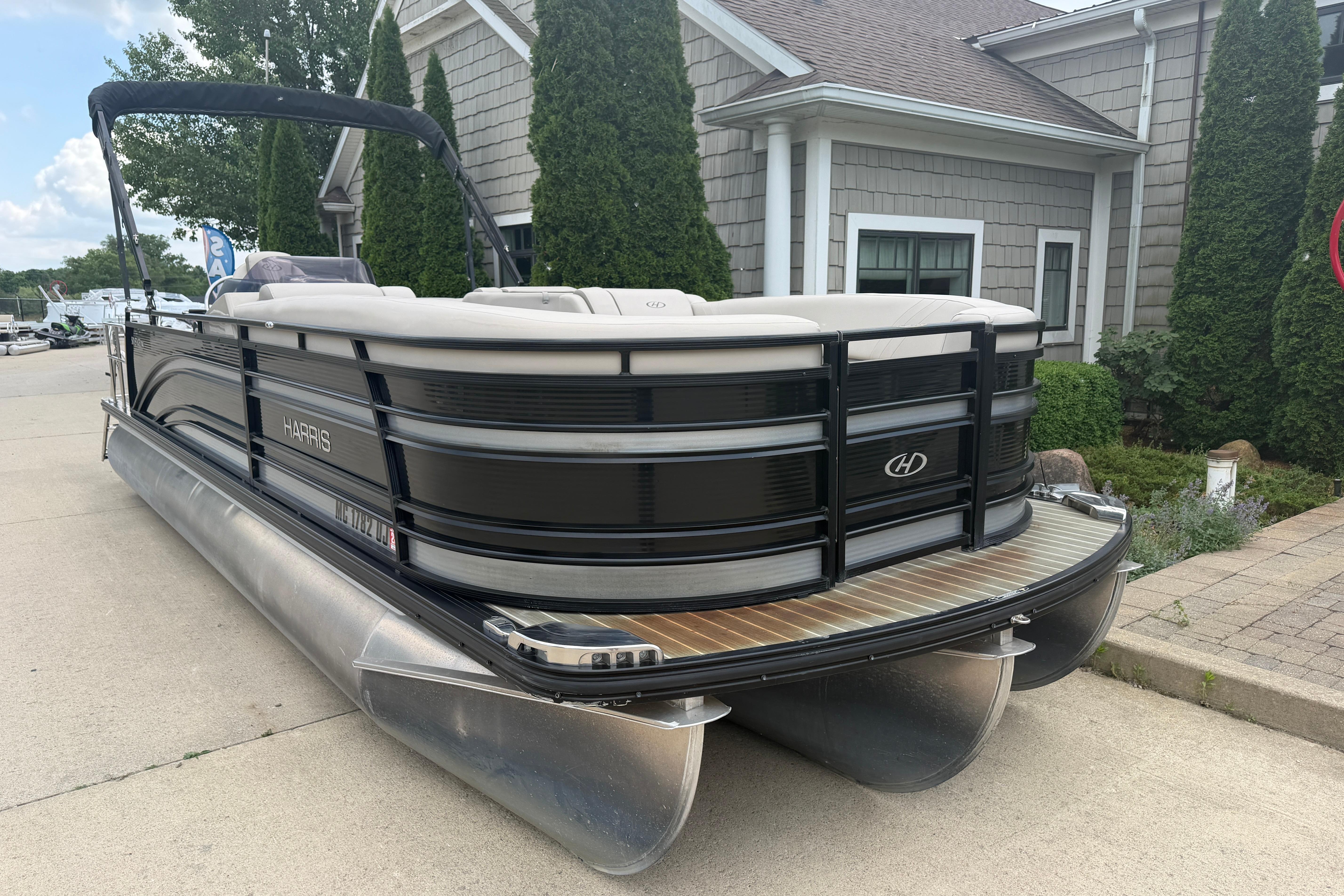 2019 Harris Solstice 240 pontoon boat parked near a building, showcasing sleek design.