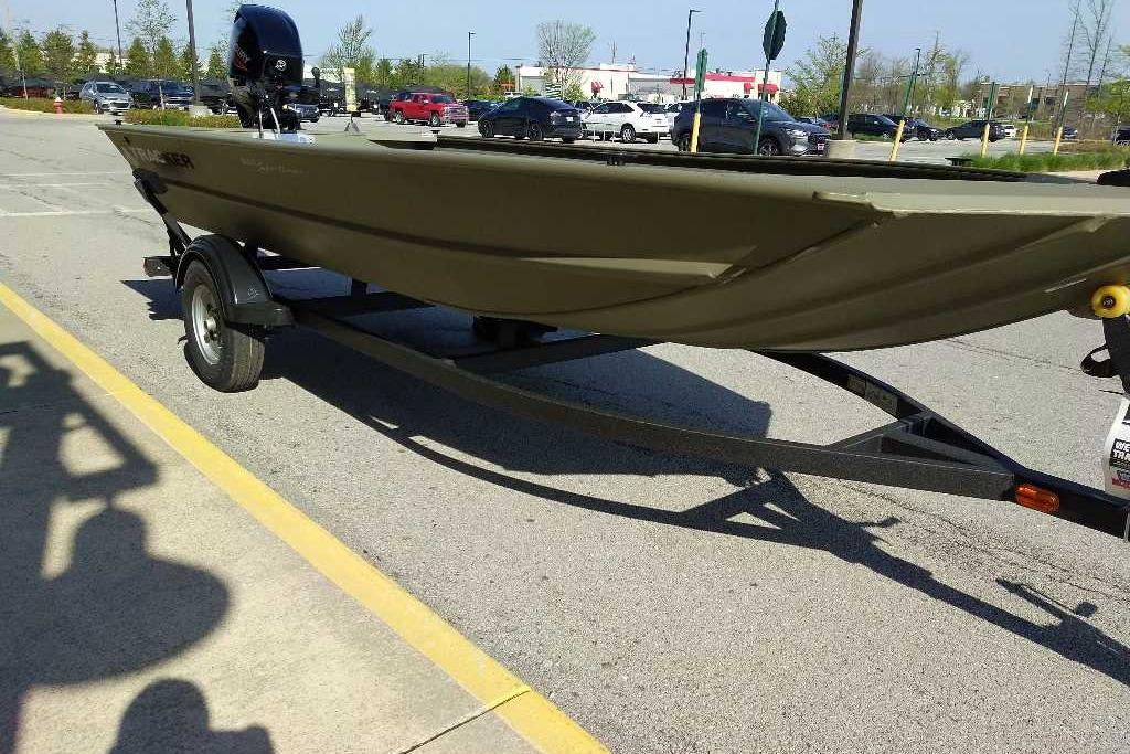 2026 Tracker Grizzly 1654 T Sportsman boat on trailer in parking lot.