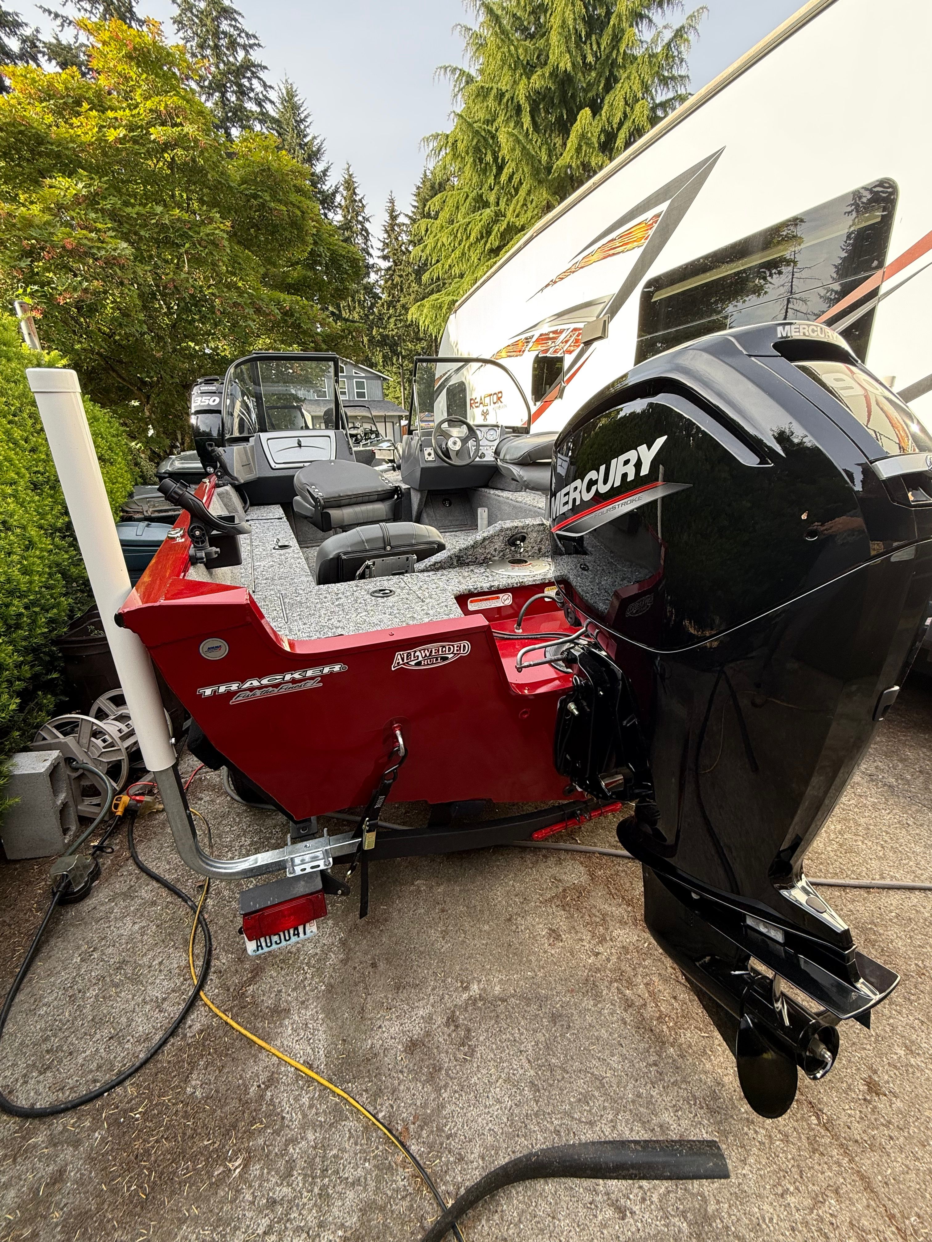 2025 Tracker Pro Guide V-16 WT boat with Mercury engine outdoors.
