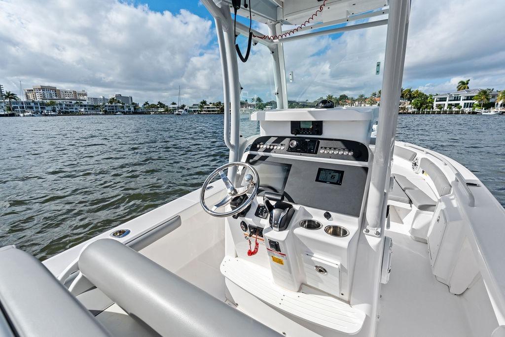 2023 Everglades 243 Center Console boat on water, featuring modern helm and controls.