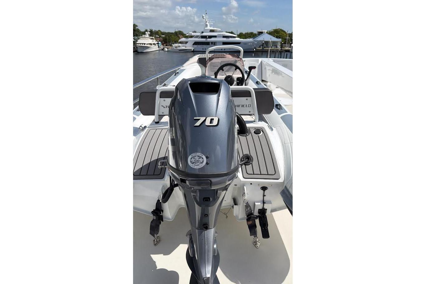 2022 Highfield Sport 420 boat with Yamaha 70 engine, docked near luxury yachts.