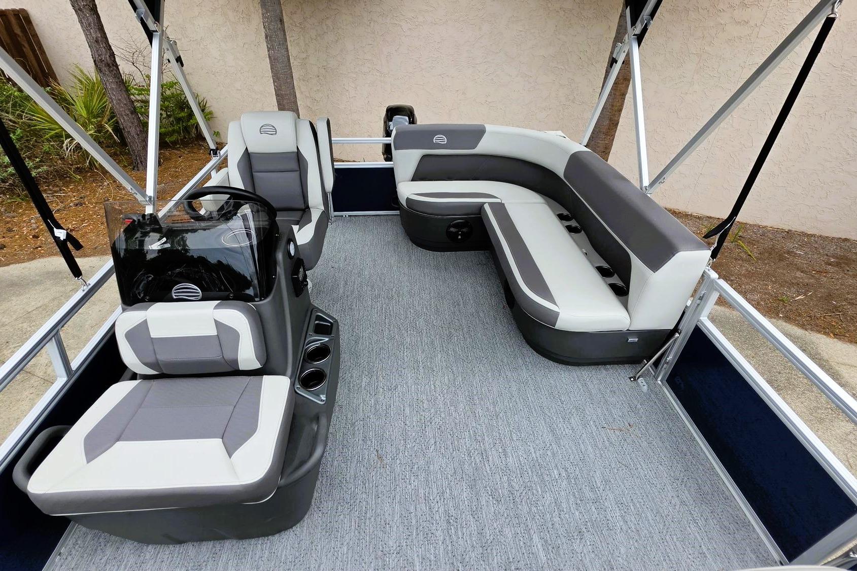 2026 Sun Tracker Bass Buggy 16 XL Select pontoon boat interior with gray seating and helm.
