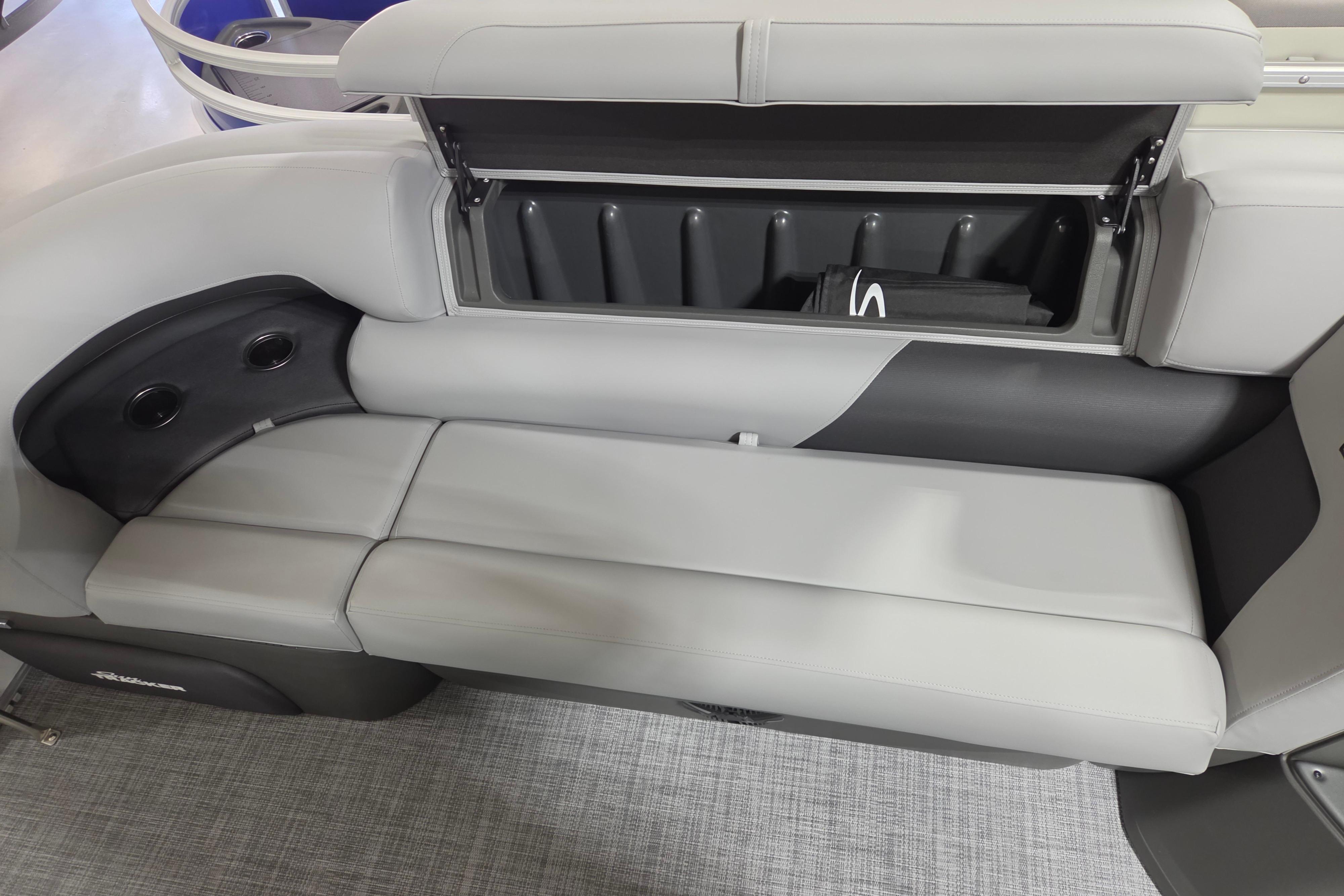 2026 Sun Tracker Party Barge 20 DLX interior seating with storage compartment open.