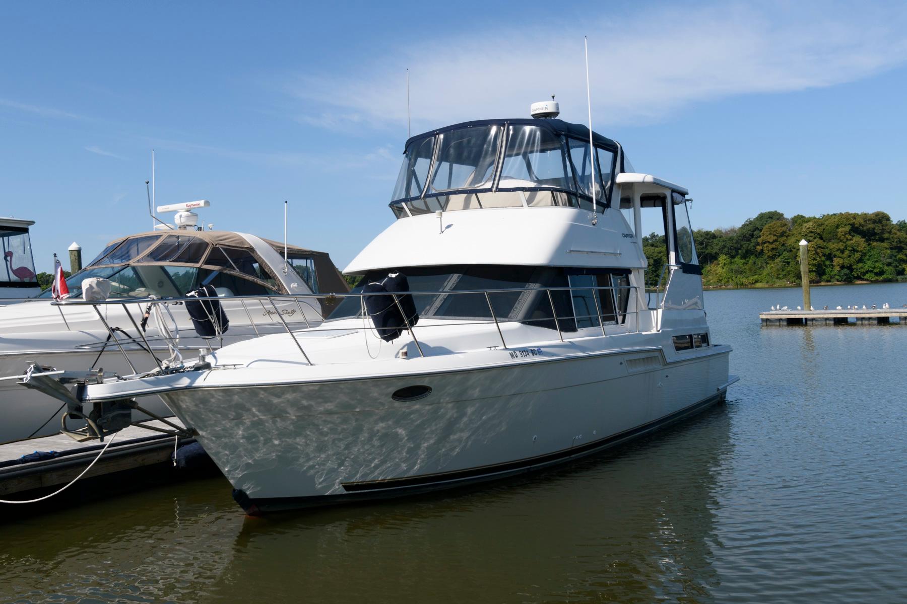 1997 Carver 400 Cockpit Motor Yacht docked at marina.
