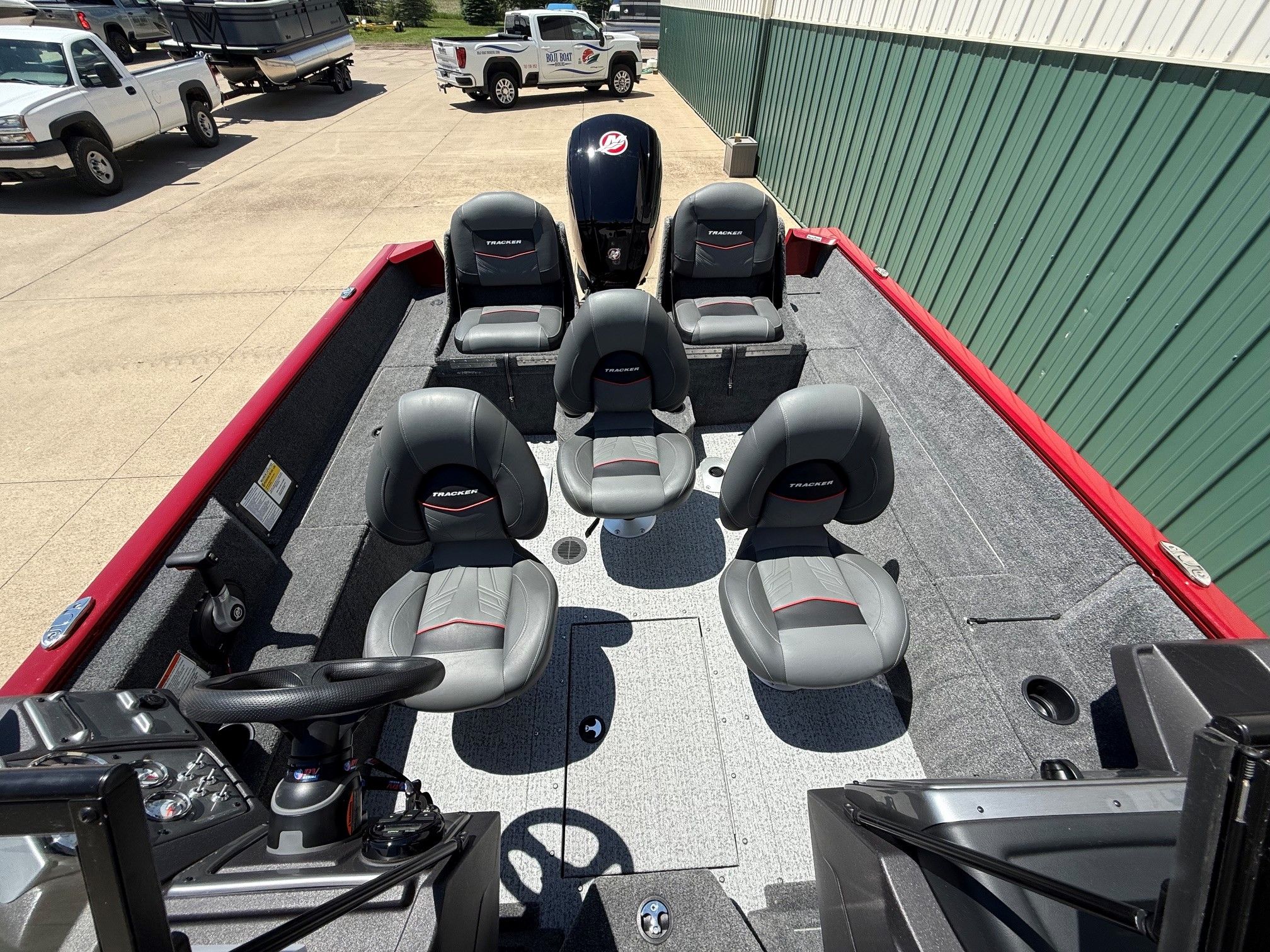 2024 Tracker Pro Guide V175 boat with gray seats outdoors.
