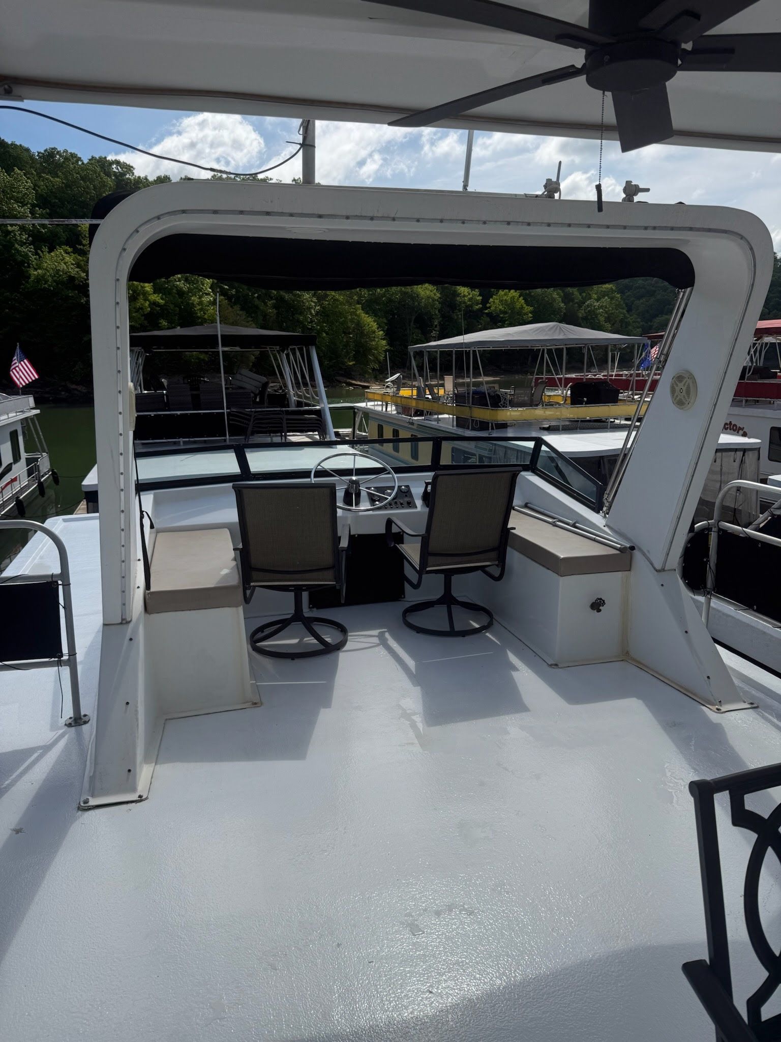 2003 Lakeview 16x70 houseboat with helm and seating area.