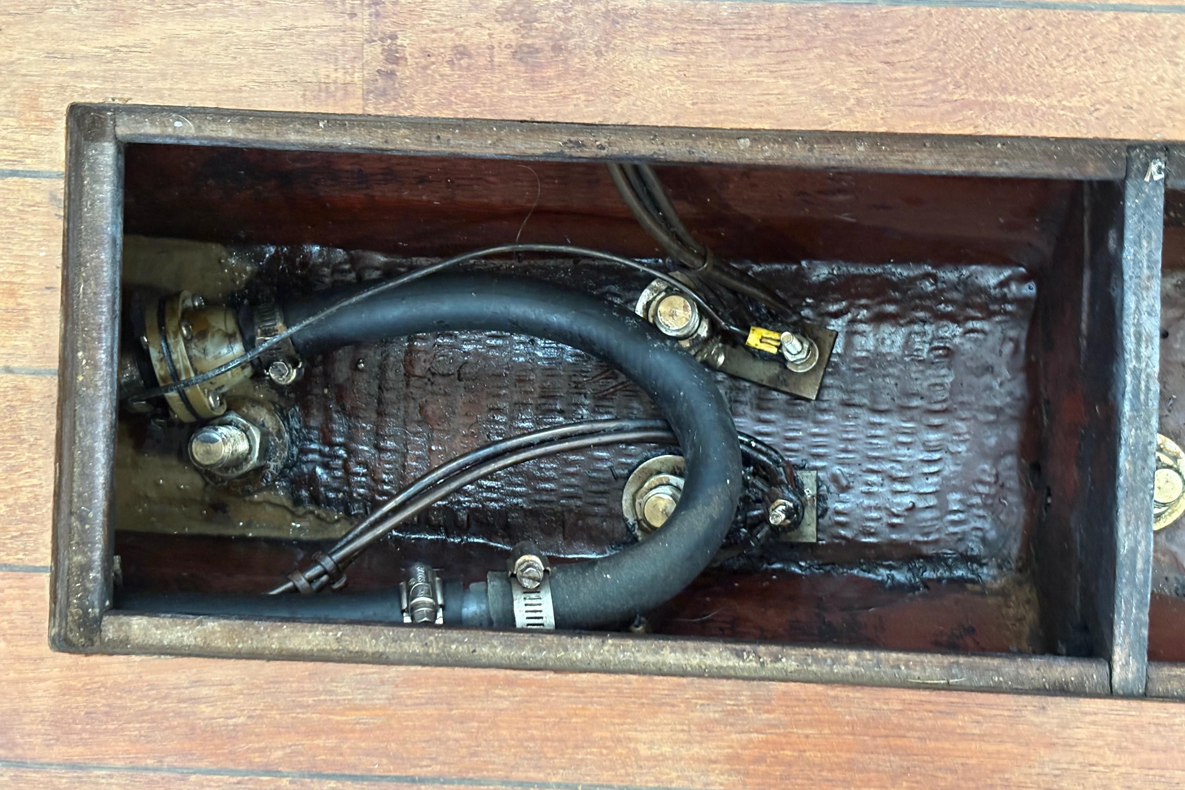 1981 Sabre 31 boat bilge with hoses and wiring visible.