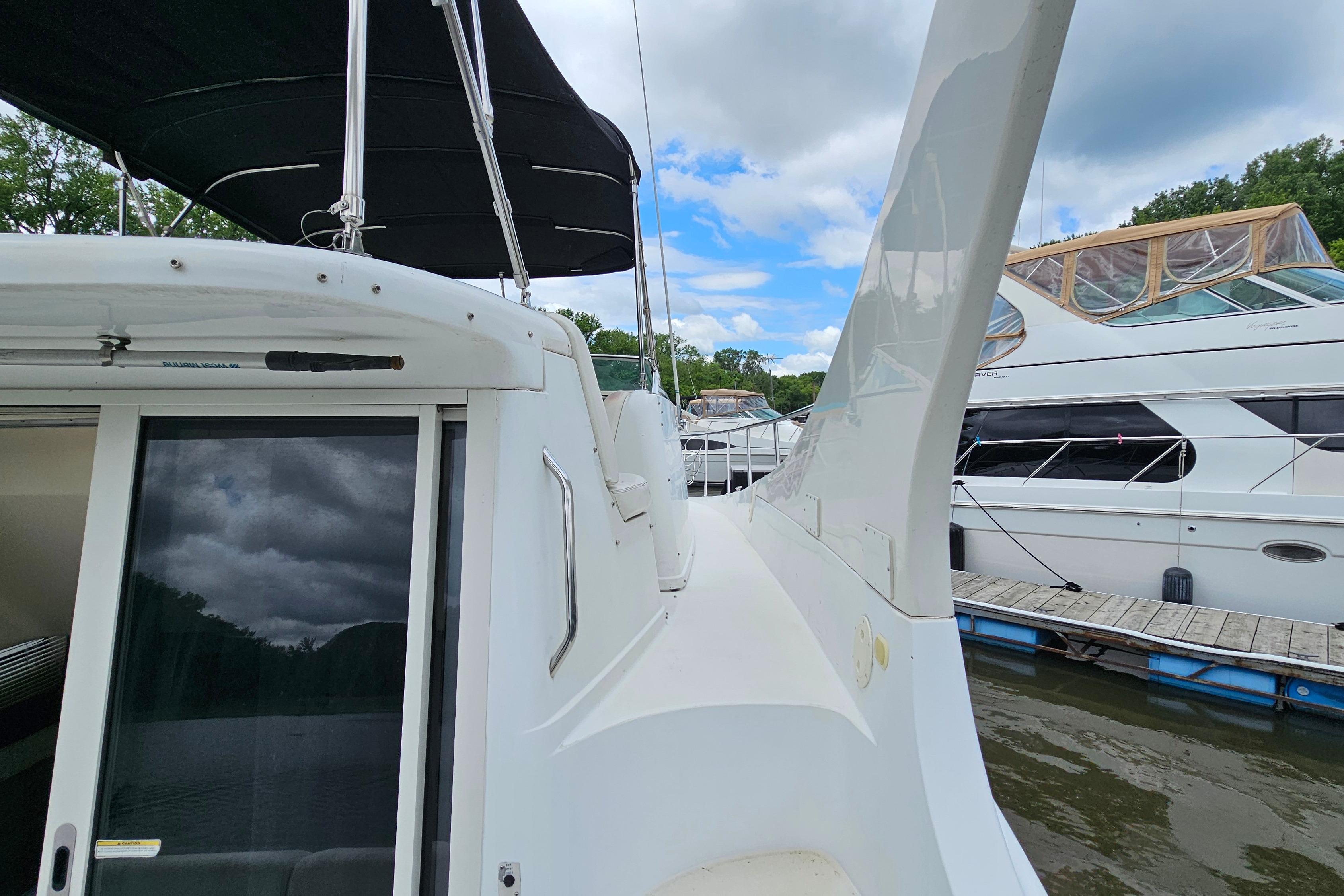 1999 Carver 350 Mariner yacht docked, featuring sleek design and spacious deck.