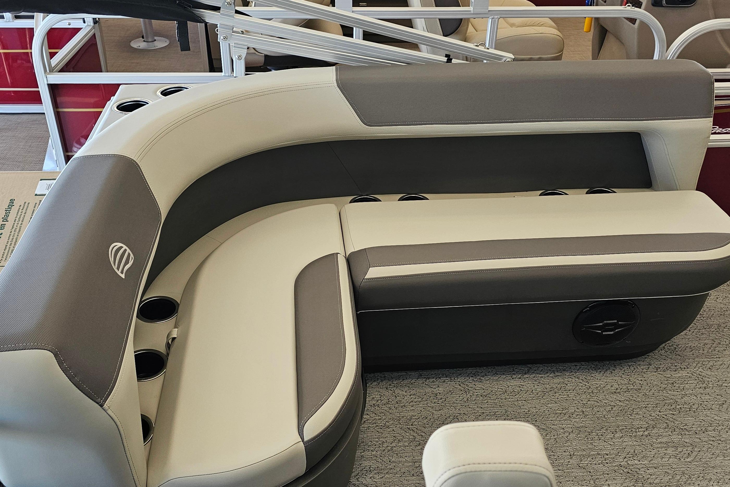 2026 Sun Tracker Bass Buggy 16 XL Select boat seating with cup holders, featuring gray and beige upholstery.