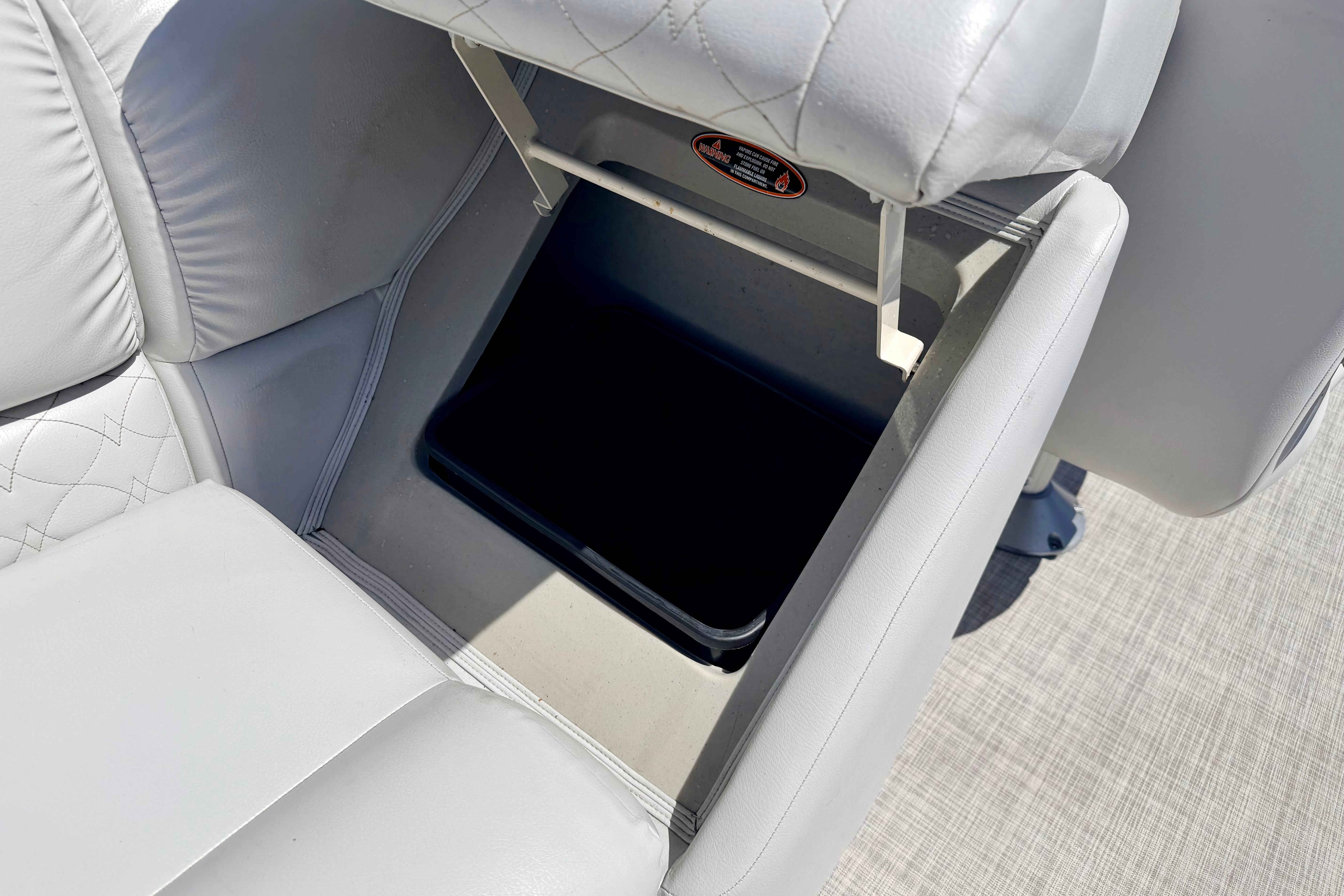 Crestliner 240 Rally DX CW 2019 boat seat with storage compartment open.