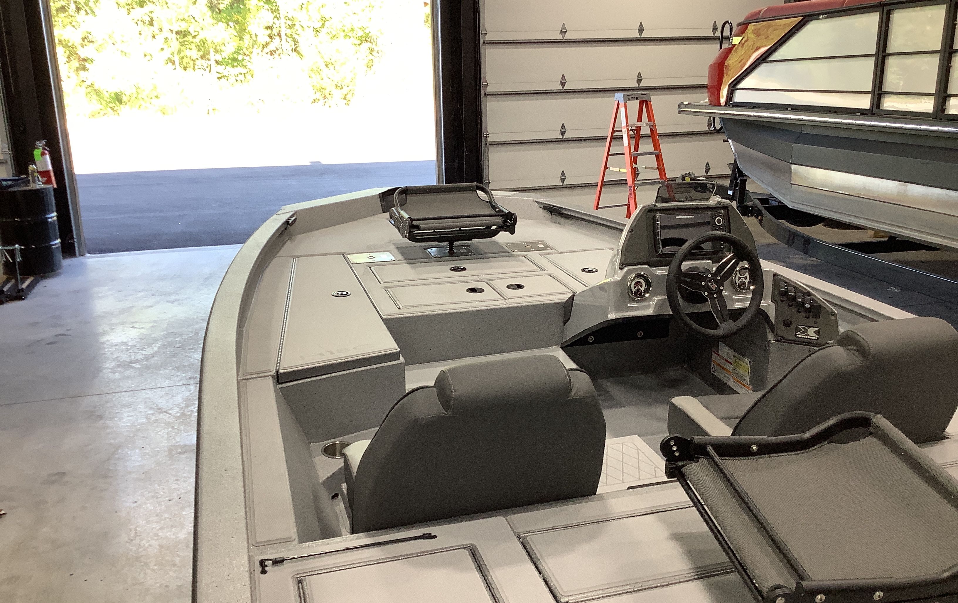 2026 Xpress Boats H18C inside a garage setting.