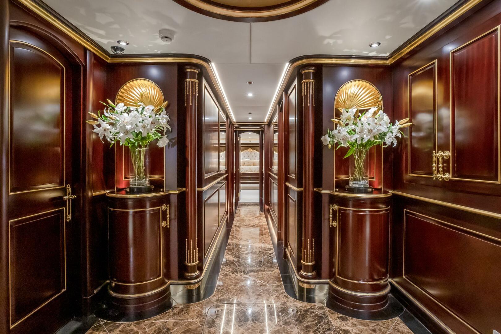Luxurious interior of 2009 Horizon Model Tri-Deck yacht with elegant wood paneling and floral decor.