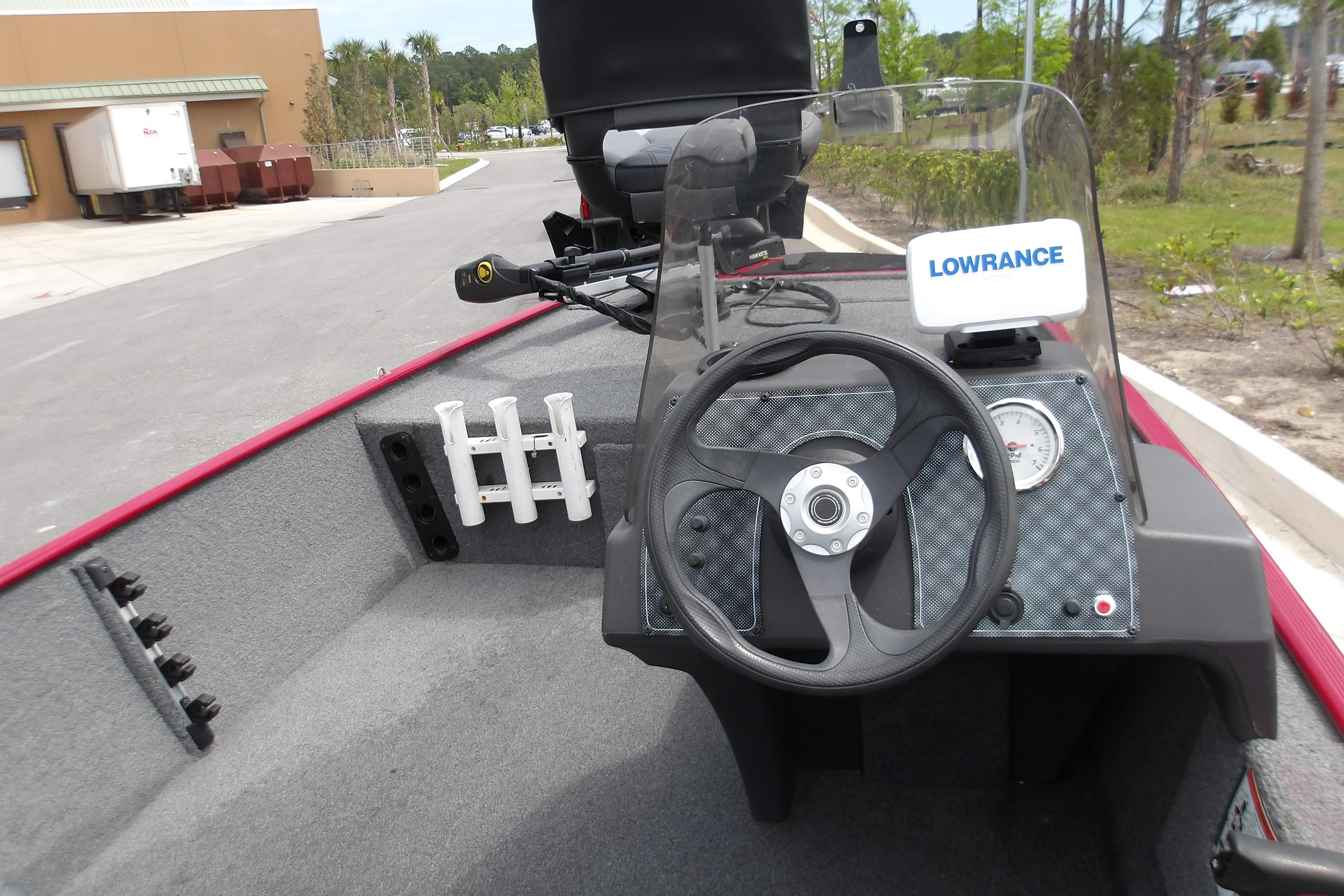 2024 Tracker Bass Tracker Classic XL boat dashboard with steering wheel and Lowrance fish finder.