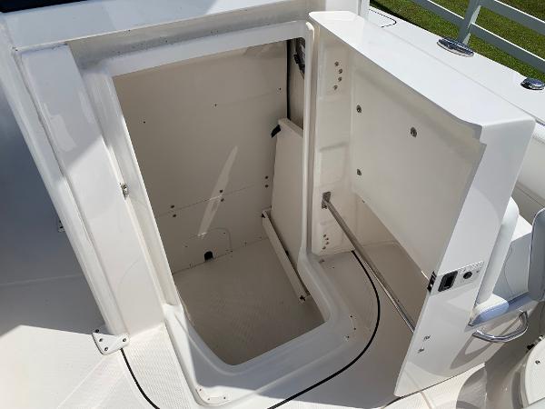 2024 Robalo 266 Cayman storage compartment with open hatch.