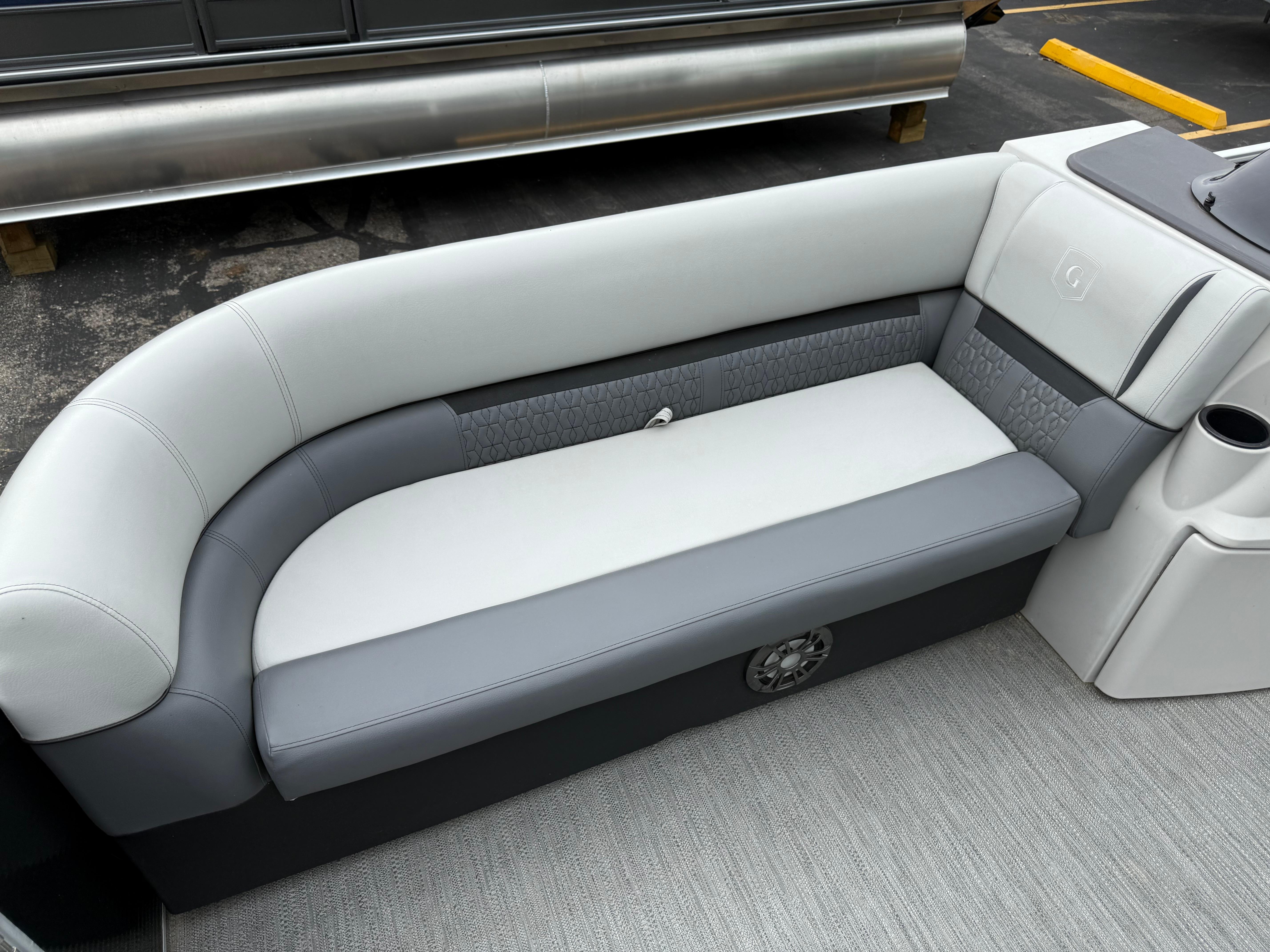 2023 Godfrey Sweetwater boat interior with gray and white cushioned seating.