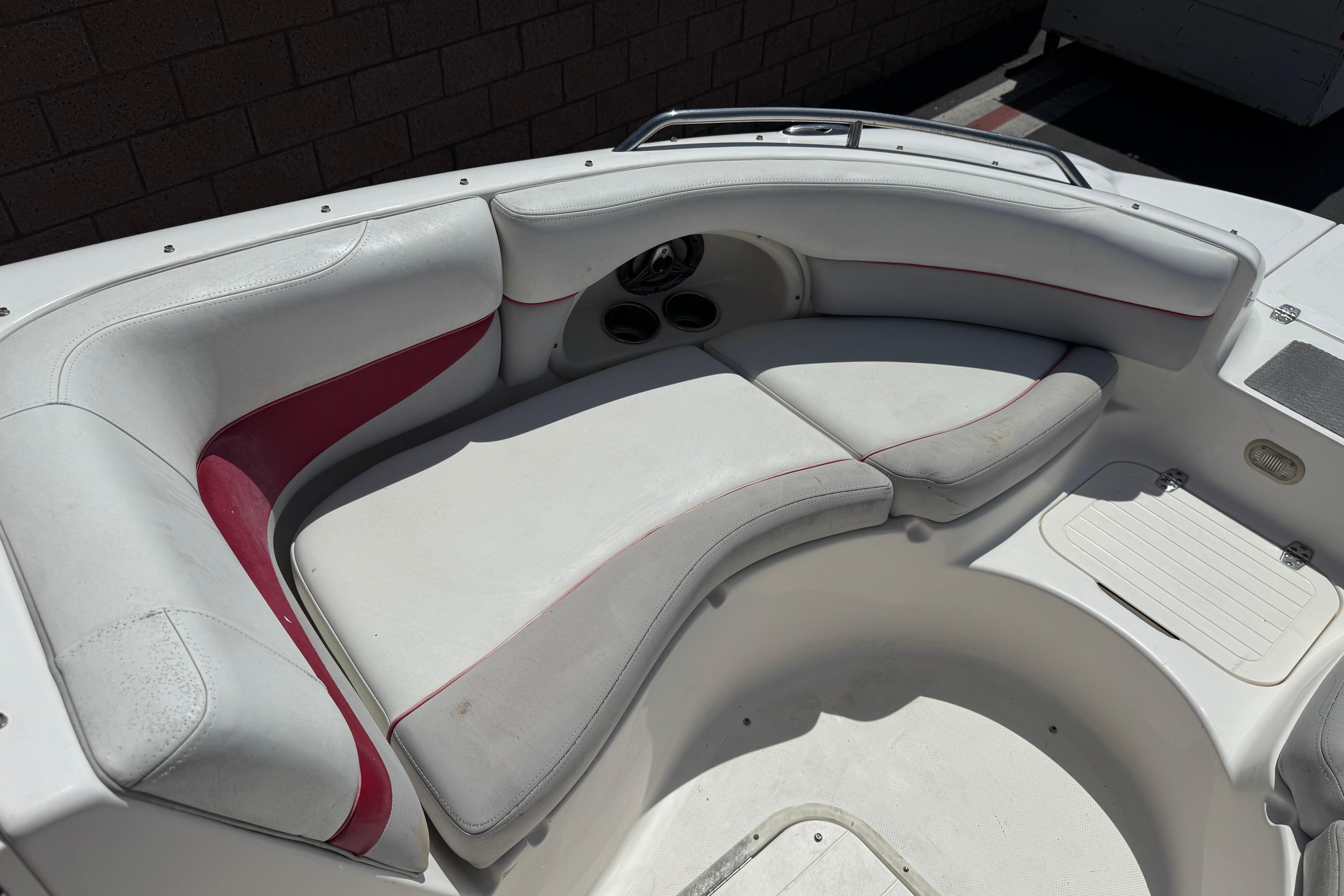 2010 Bryant 255 boat interior with white and red cushioned seating.