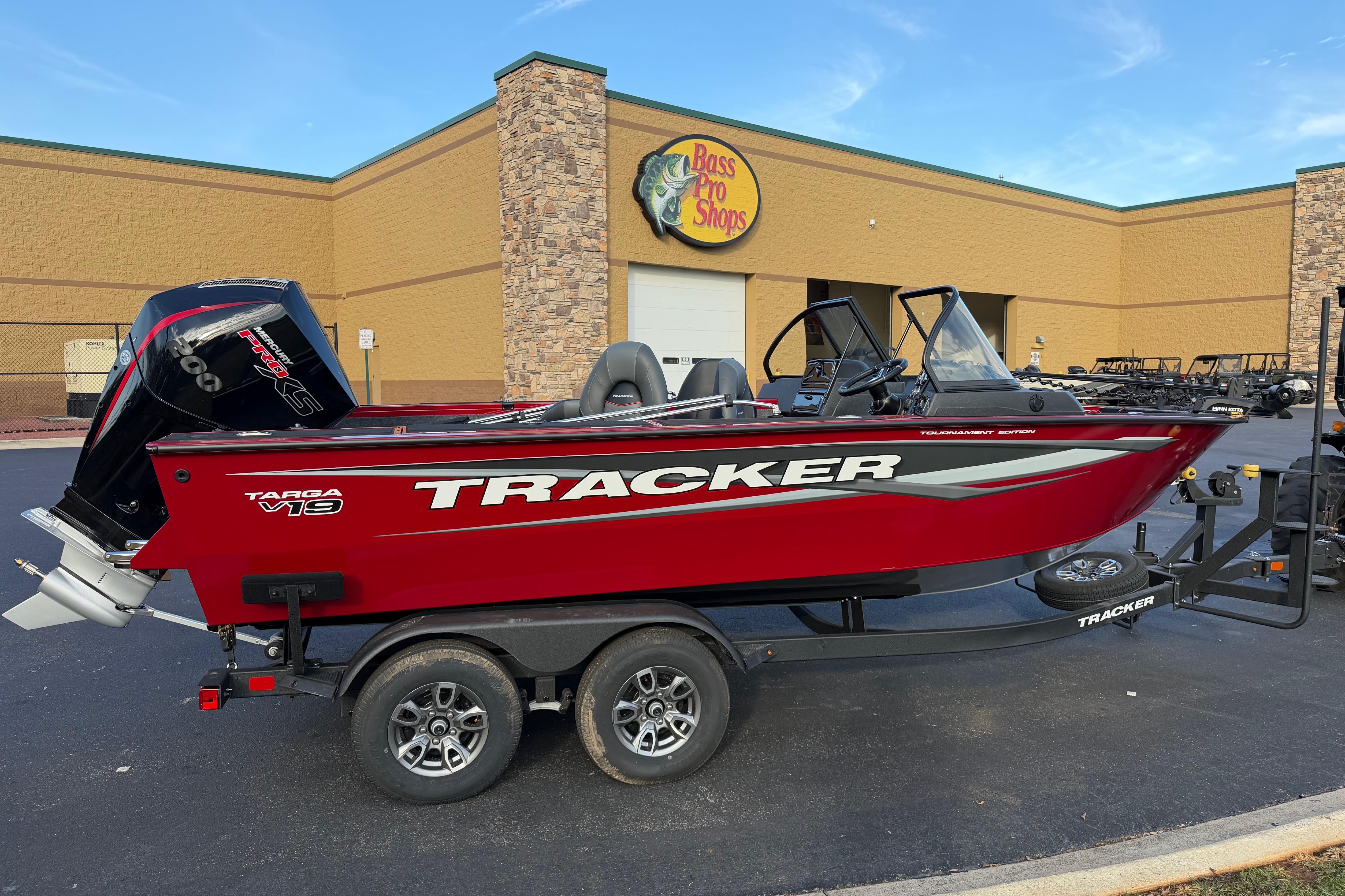 2026 Tracker Targa V-19 Combo boat in red, parked outside Bass Pro Shops.