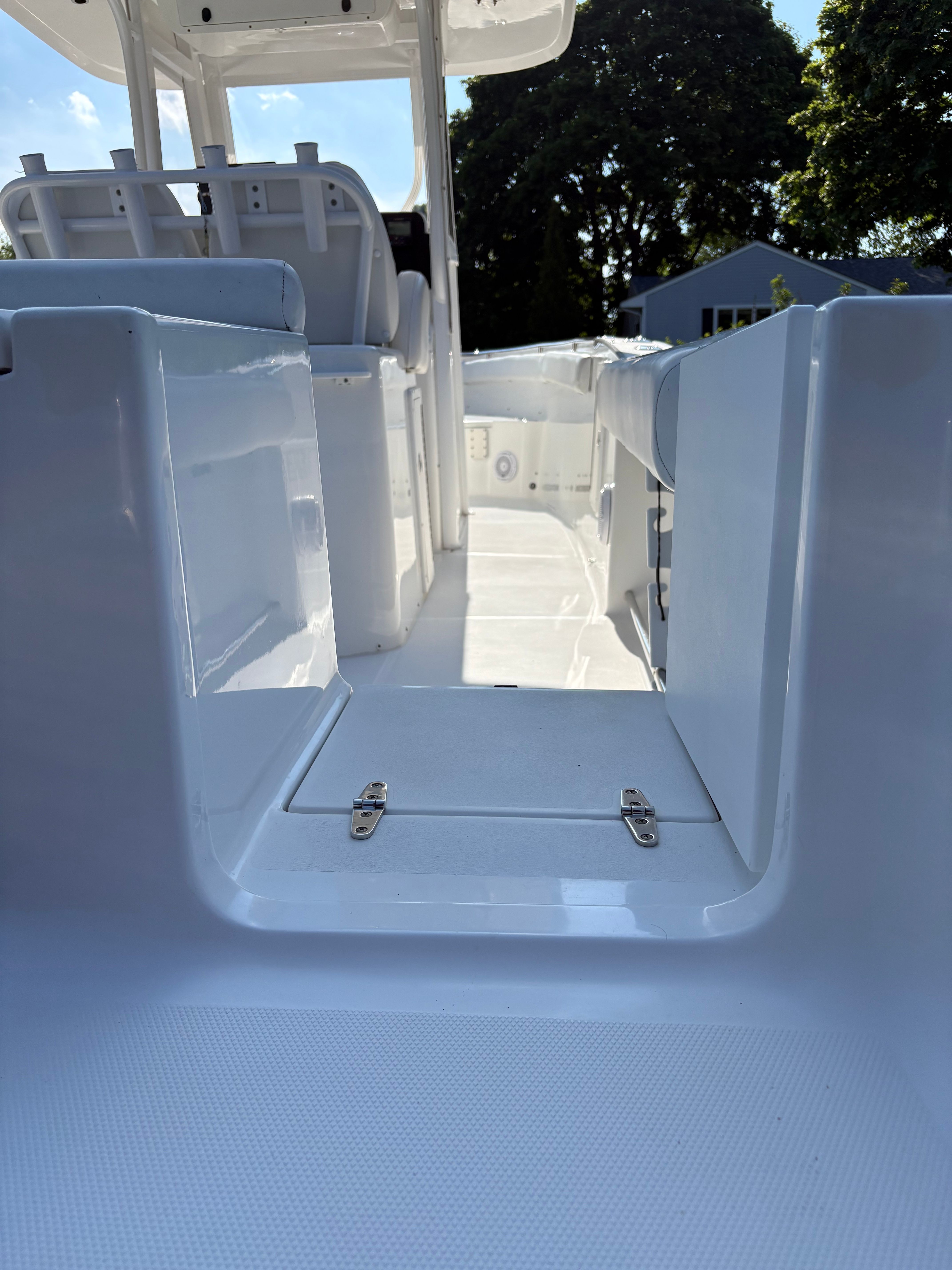 View of a Sea Hunt Gamefish 29 boat deck, featuring white seating and a clear pathway.