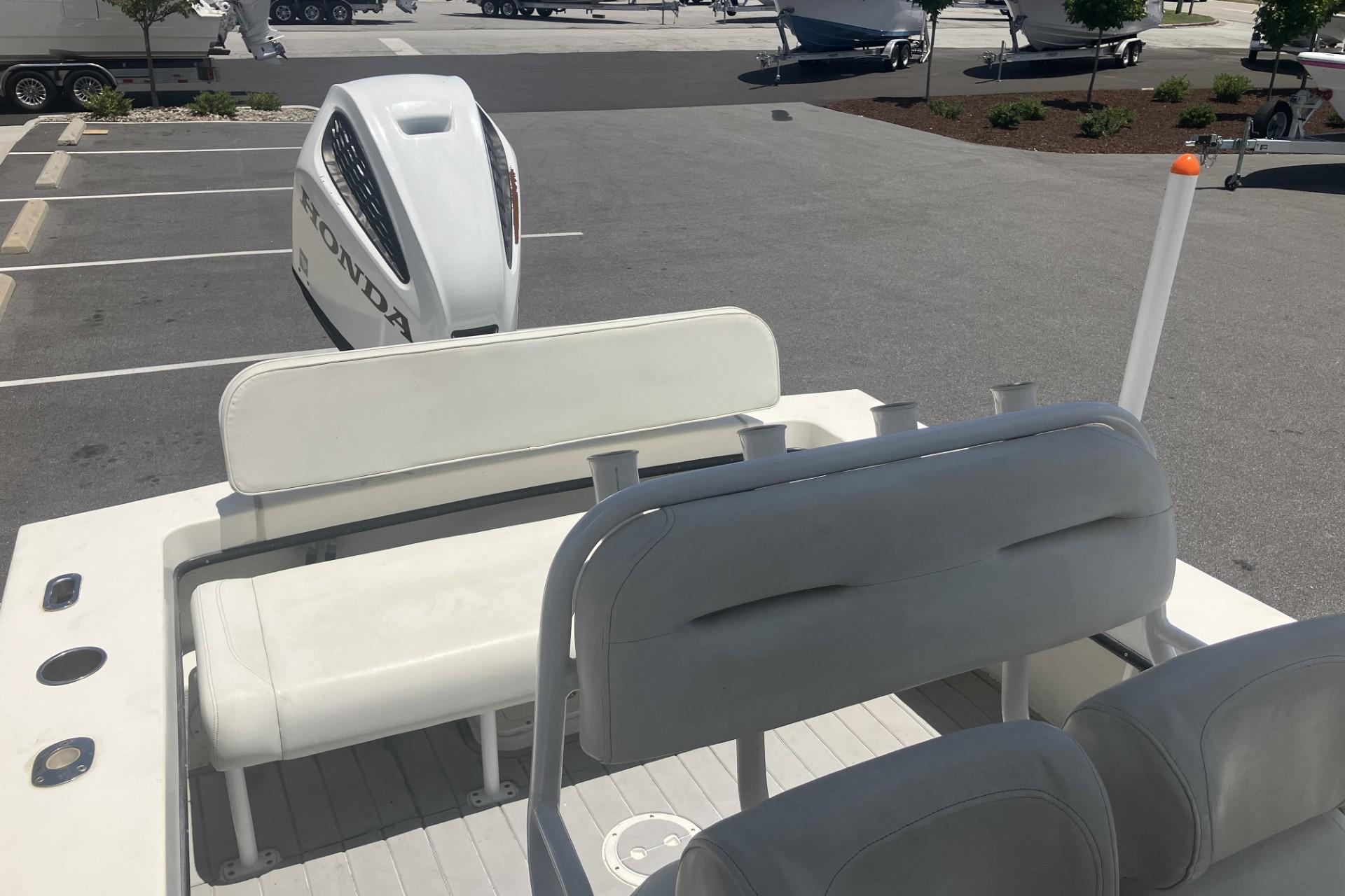 2022 May-Craft 2300 CCX boat interior with Honda outboard motor in parking lot.
