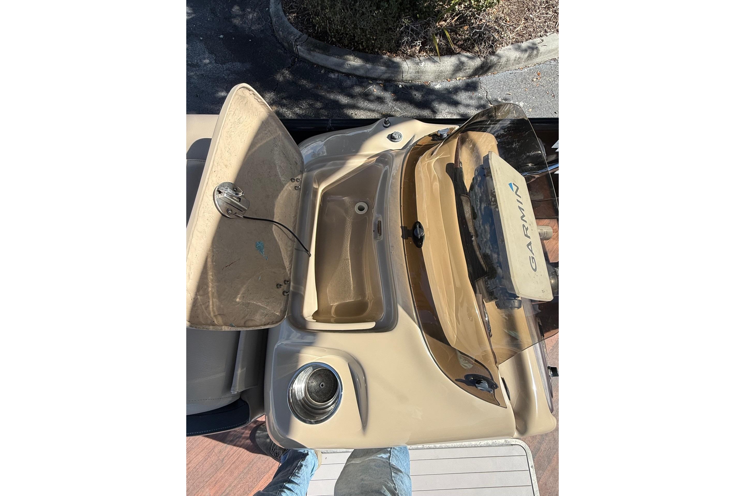 2017 South Bay 523RS boat console with Garmin navigation system and open storage compartment.