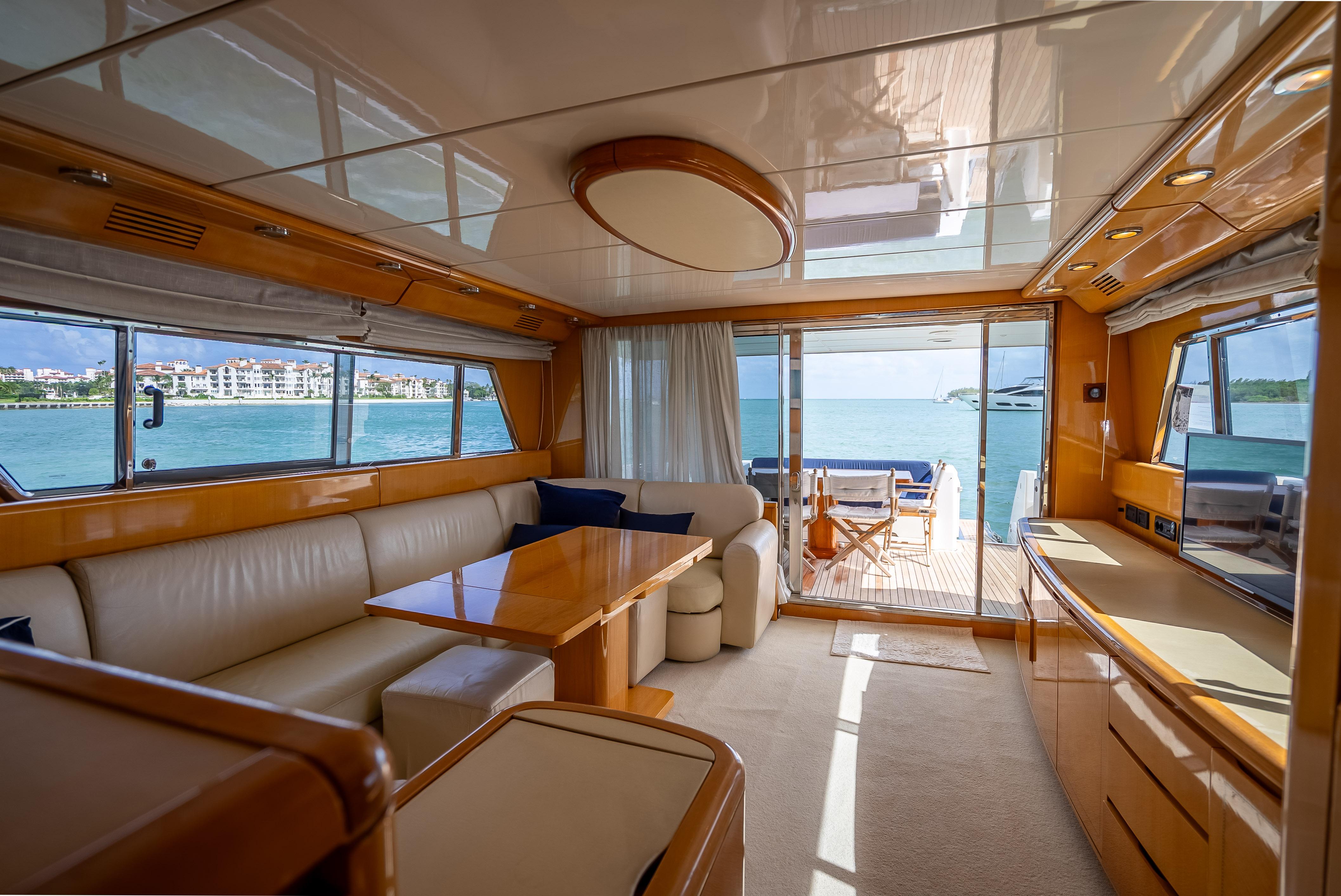 Luxurious interior of 1995 Sanlorenzo 62 yacht with ocean view and elegant furnishings.