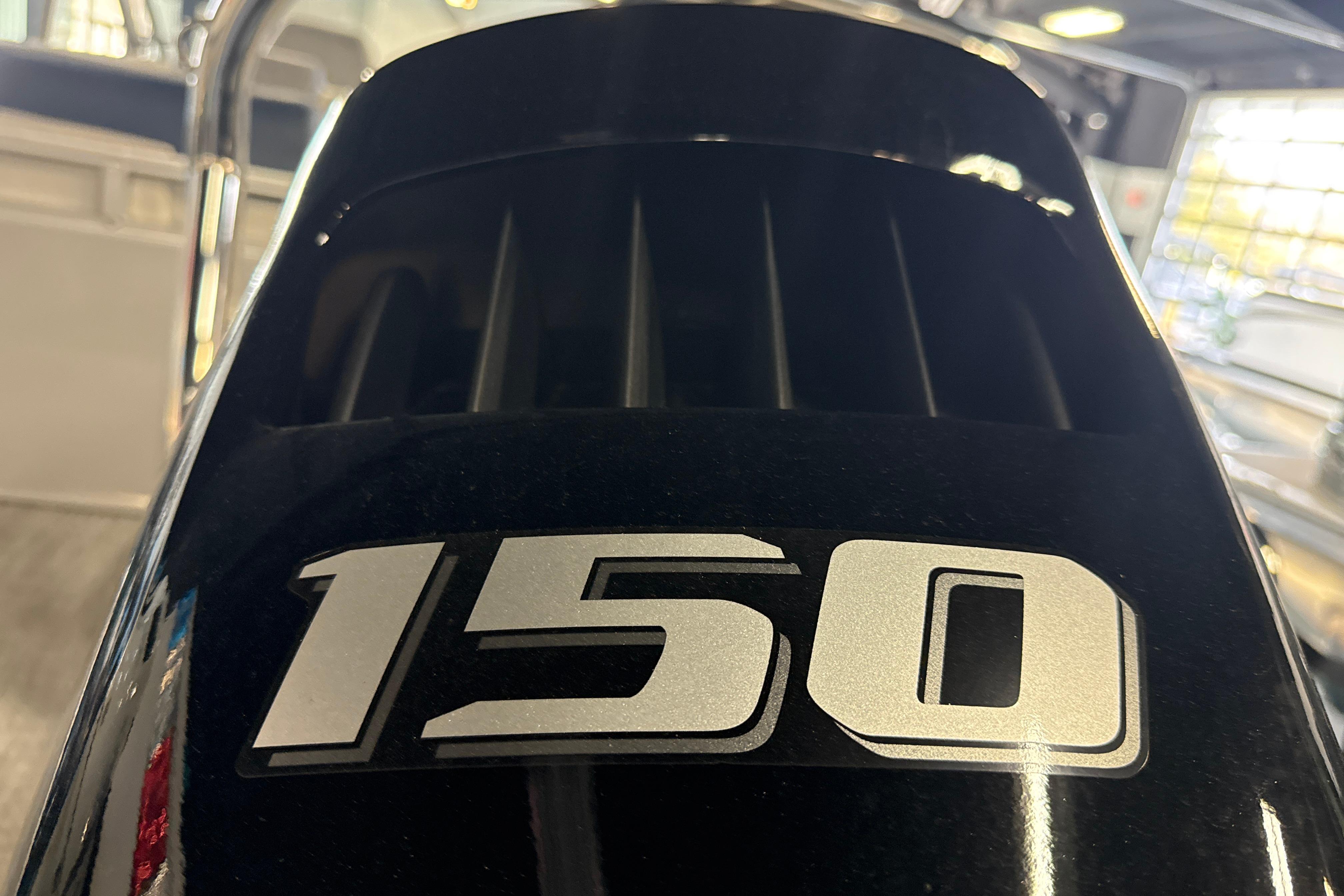 Close-up of a 150 horsepower engine on a 2026 Tahoe Pontoon LTZ Quad Lounger.