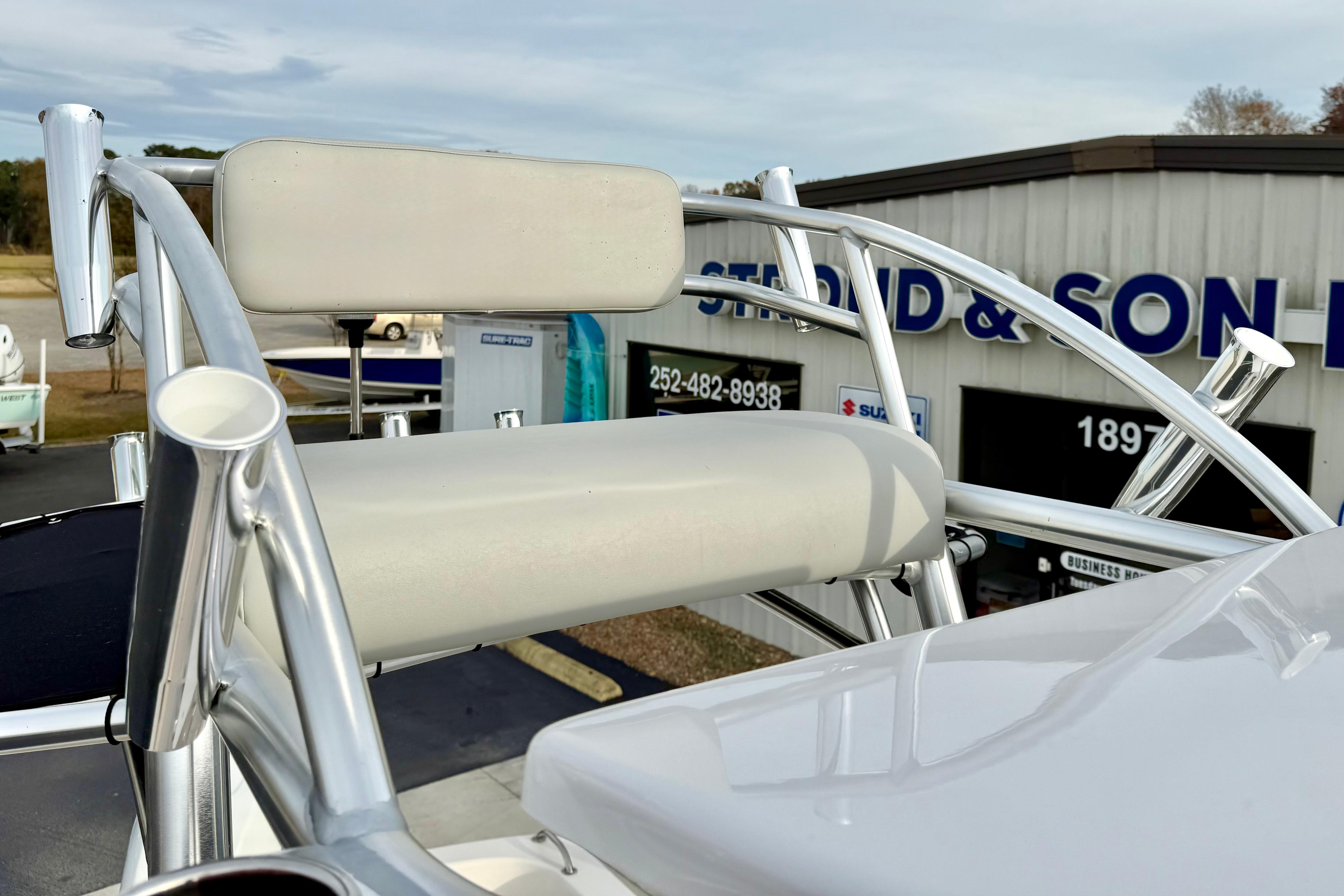 2025 Carolina Skiff 21 LS boat seat and rod holders at dealership.