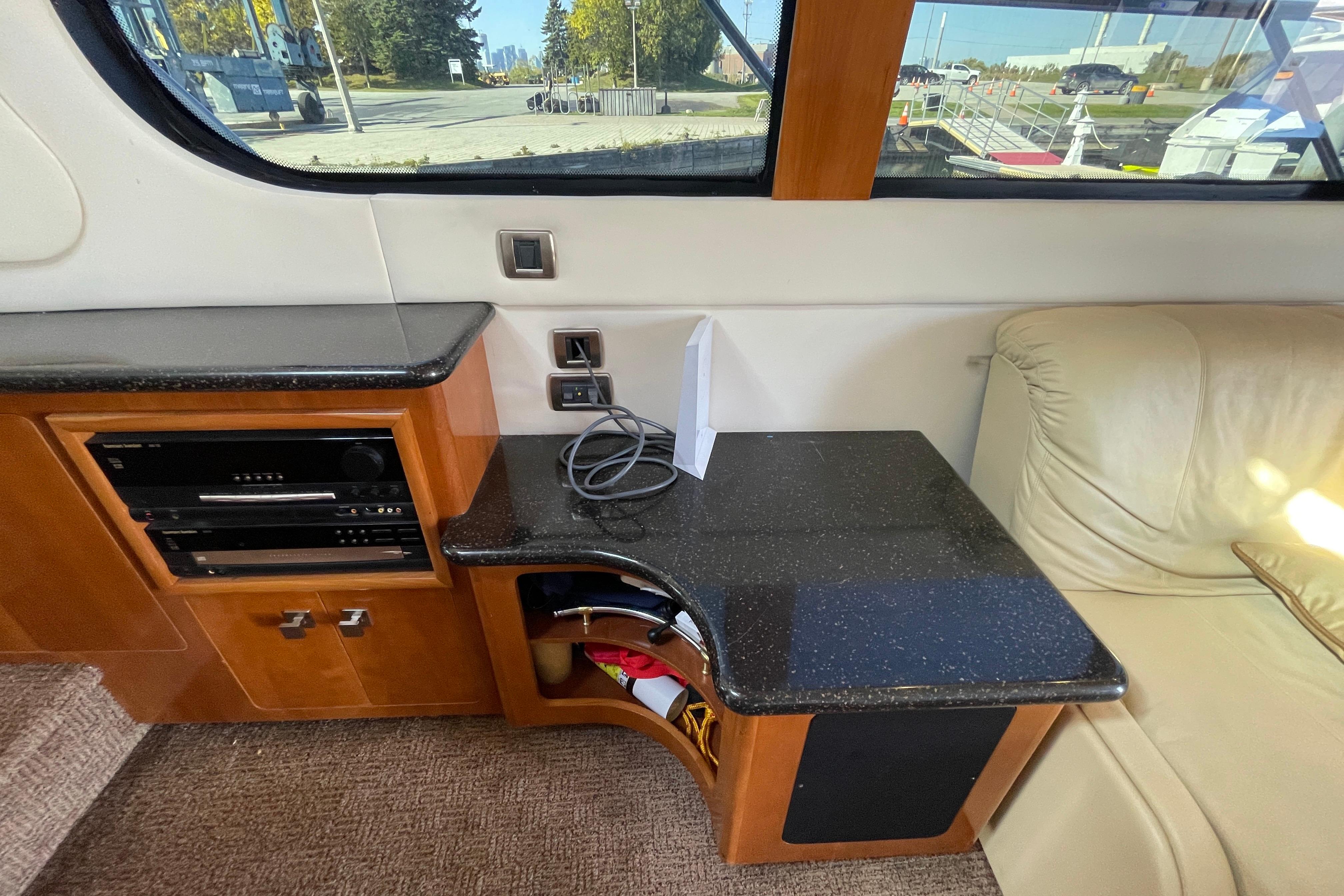 Interior of 2002 Carver 570 Voyager Pilothouse with entertainment system and seating area.