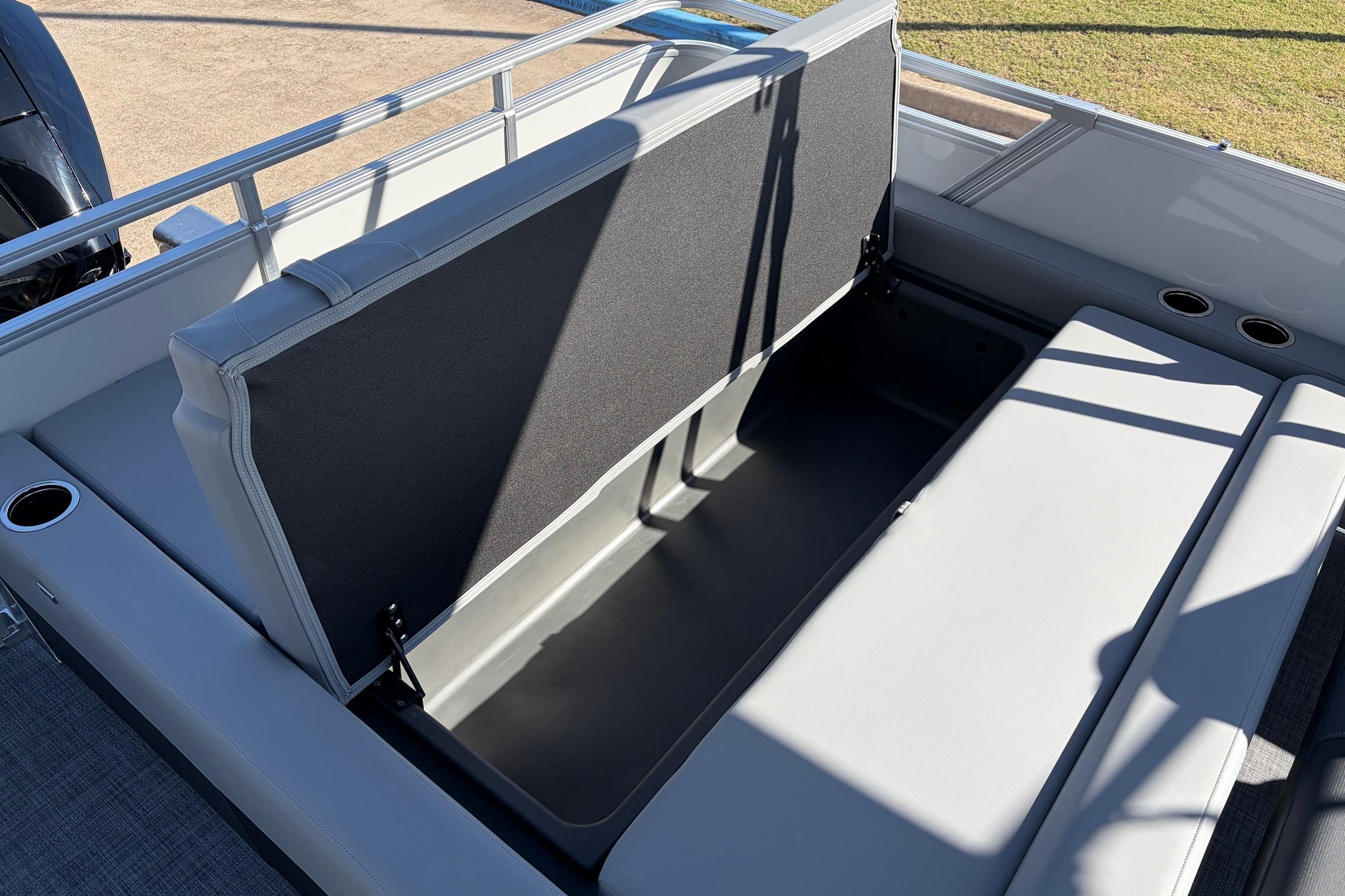 2026 Sun Tracker Party Barge 22 RF XP3 storage compartment with open seat and cup holders.
