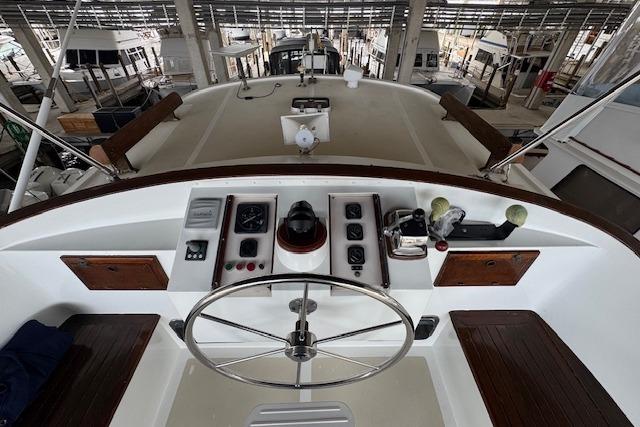 1986 Krogen 42 Classic yacht helm with steering wheel and navigation controls.