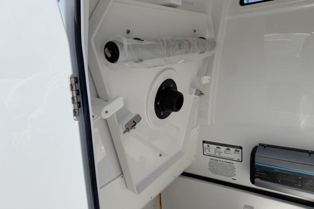 Interior view of 2026 Sportsman Open 252 Center Console boat, featuring storage compartment.