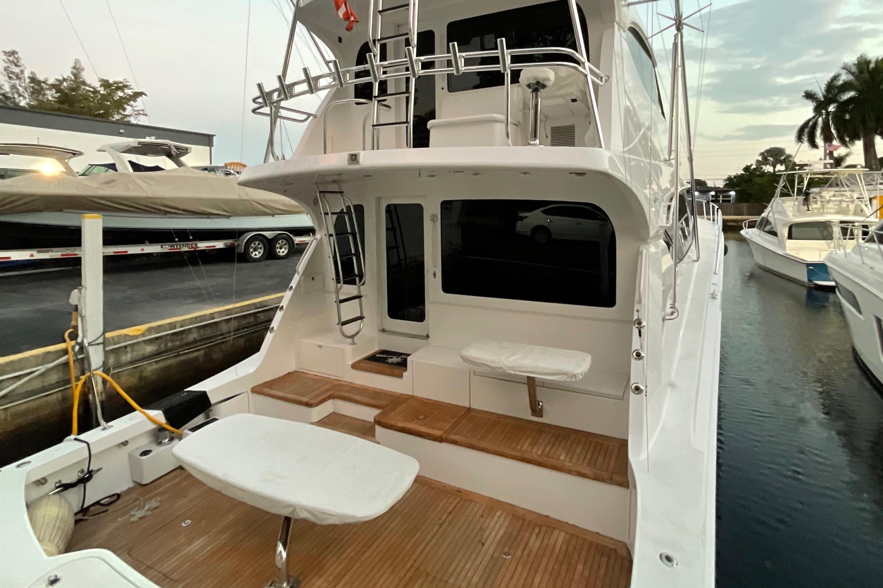 2008 Hatteras 77 Convertible yacht with spacious deck and seating area.