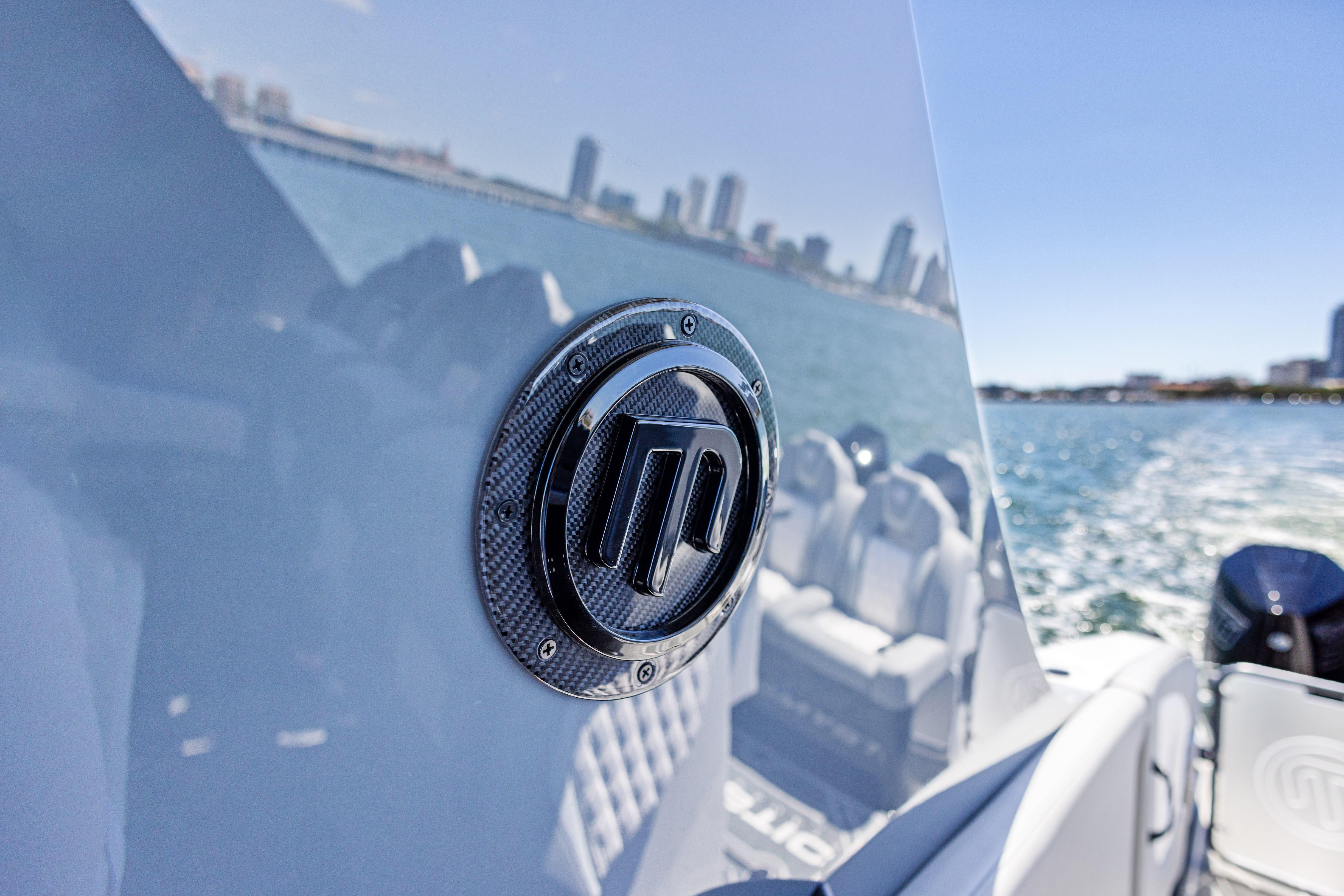 2026 Mystic Powerboats M4200 emblem on sleek boat, city skyline in background.