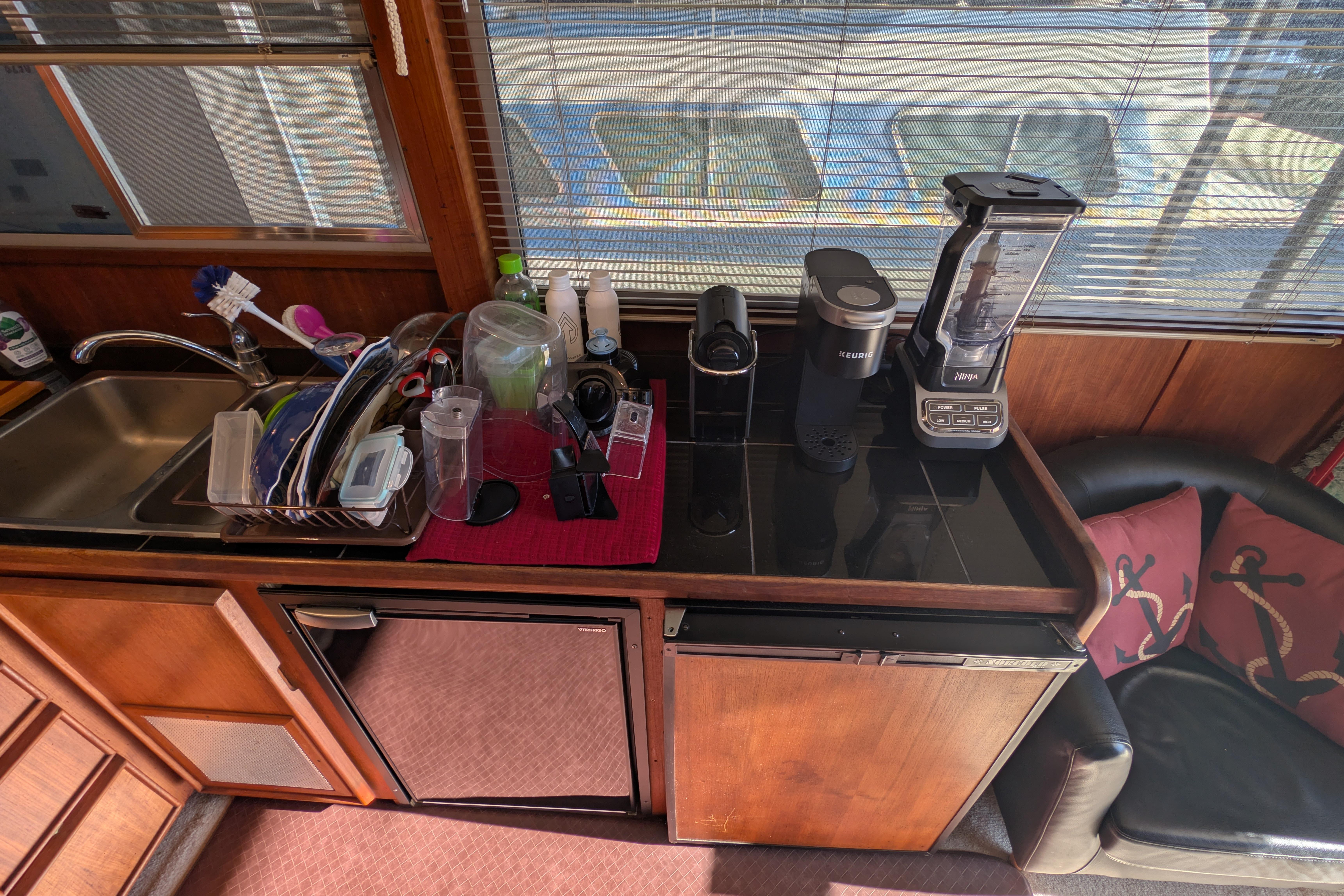 1984 Chris-Craft 382 Commander kitchen with sink, appliances, and window view.