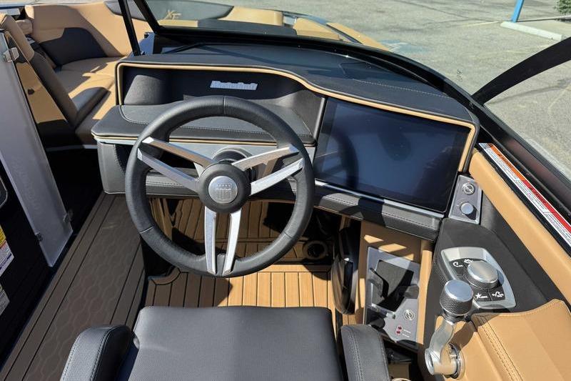 Interior view of 2026 MasterCraft XT22 boat dashboard with modern steering and controls.