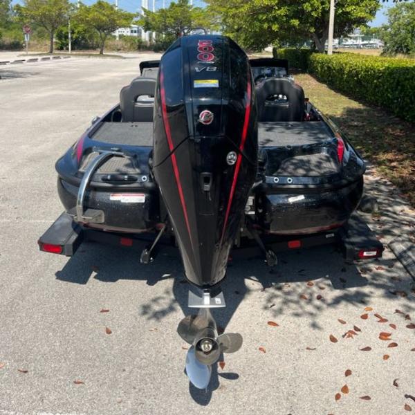 2024 Nitro Z19 boat with powerful outboard motor in a parking lot.