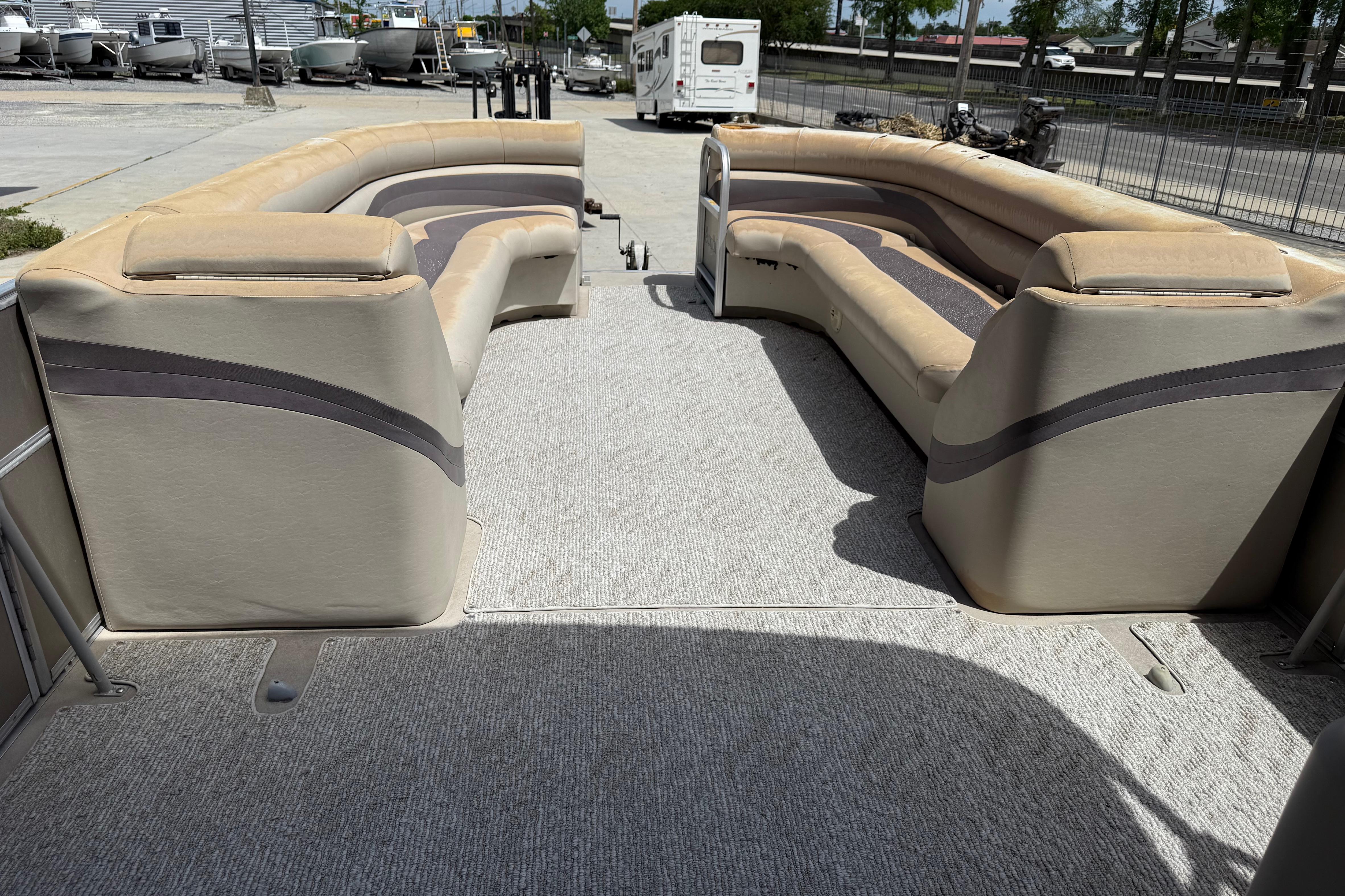2012 South Bay 522 CR pontoon boat interior with beige seating and carpeted floor.