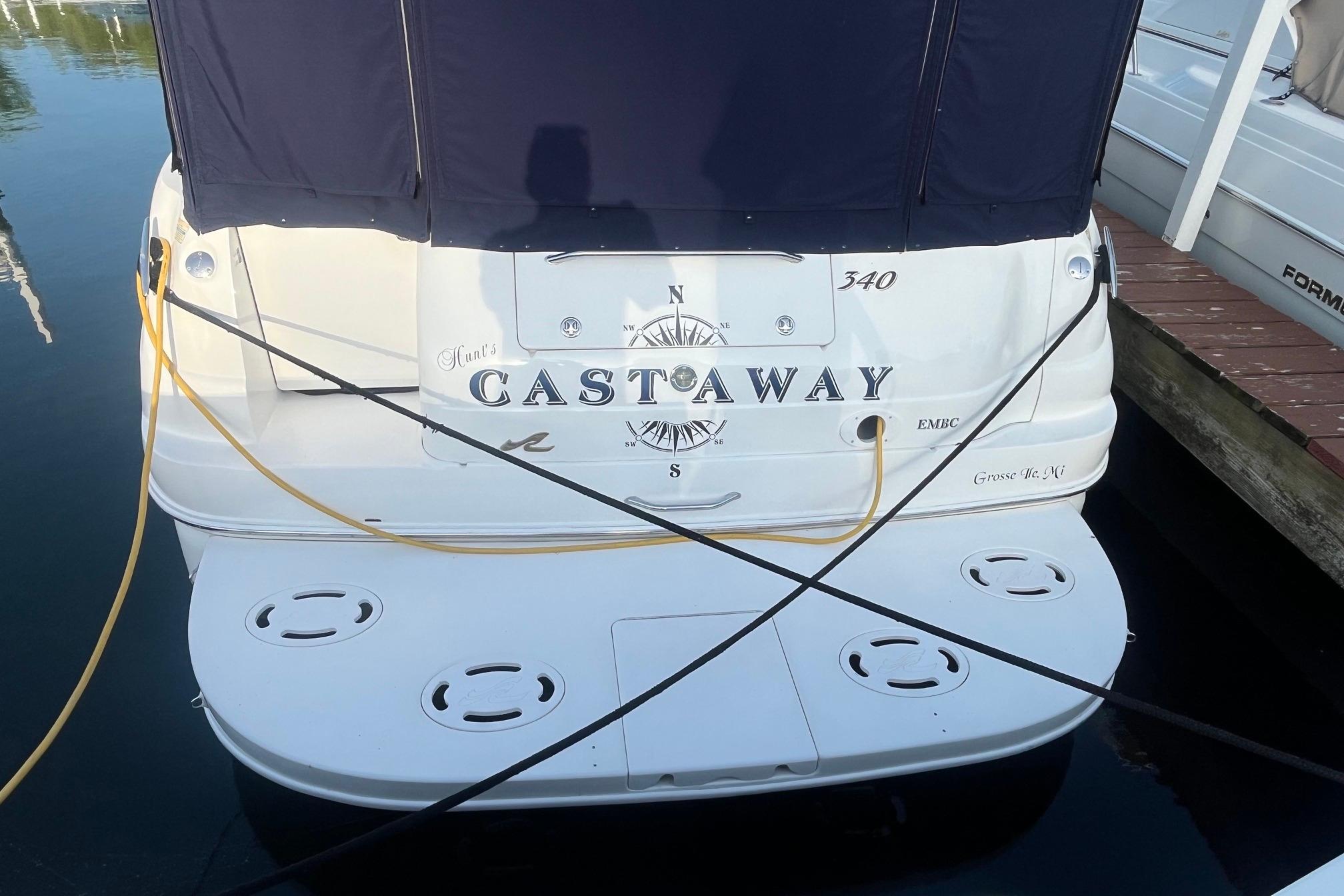 2001 Sea Ray 340 Sundancer boat named "Castaway" docked at marina.
