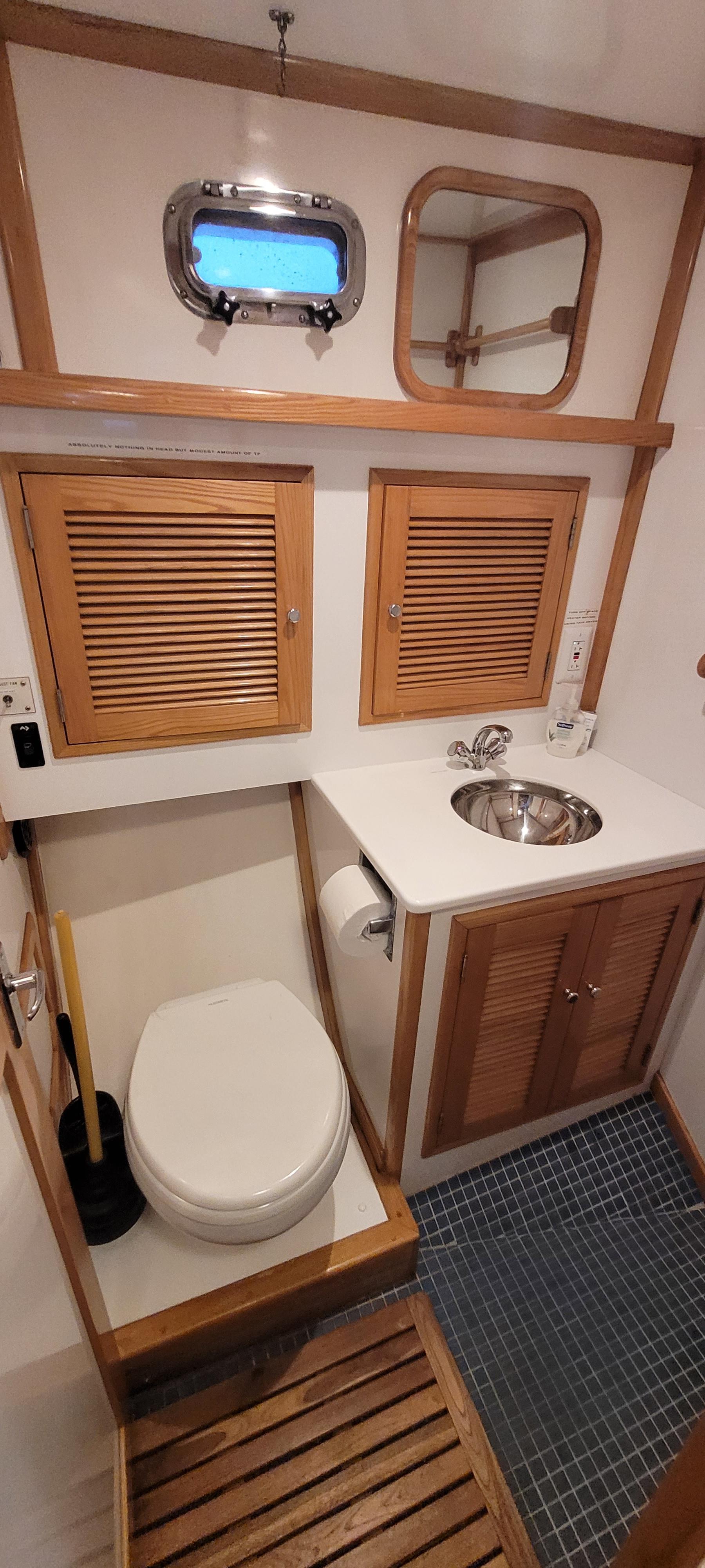 1989 Duffy Wilbur 42 Flybridge Cruiser bathroom with wooden accents and compact design.