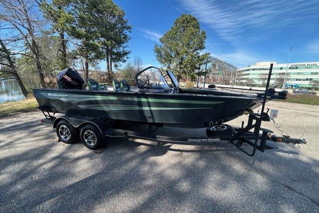 2025 Ranger VX1988 WT boat on trailer, parked outdoors near trees and buildings.