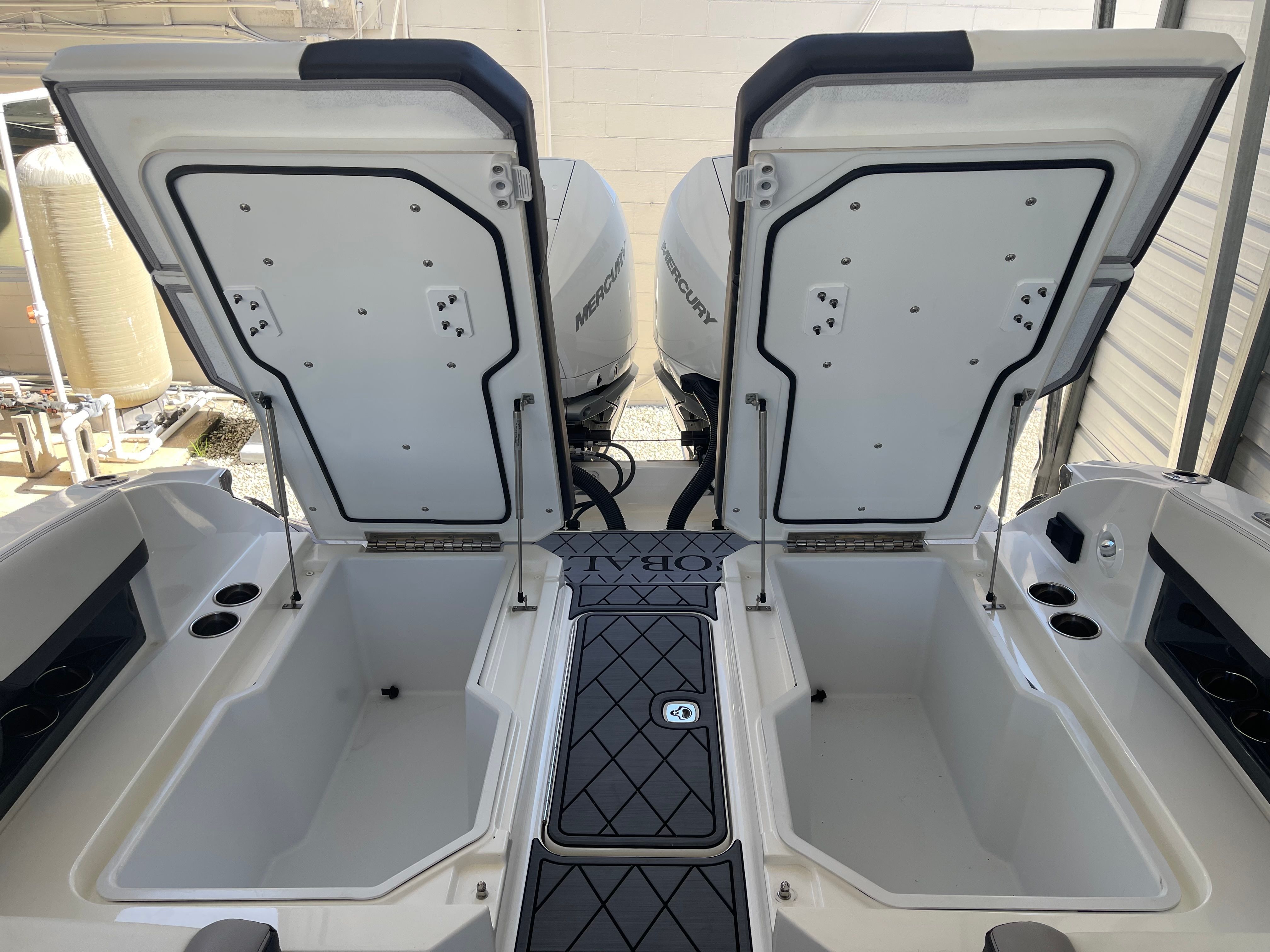 2022 Cobalt R8 Outboard boat with open storage compartments.