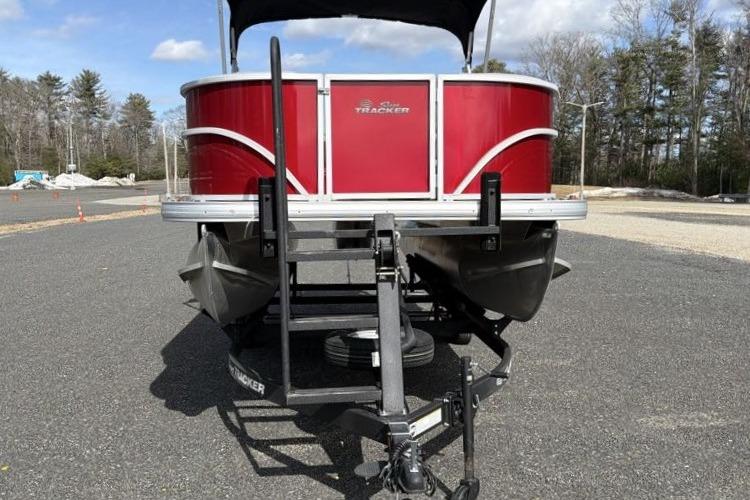 2026 Sun Tracker Party Barge 16 DLX pontoon boat on trailer, red exterior.
