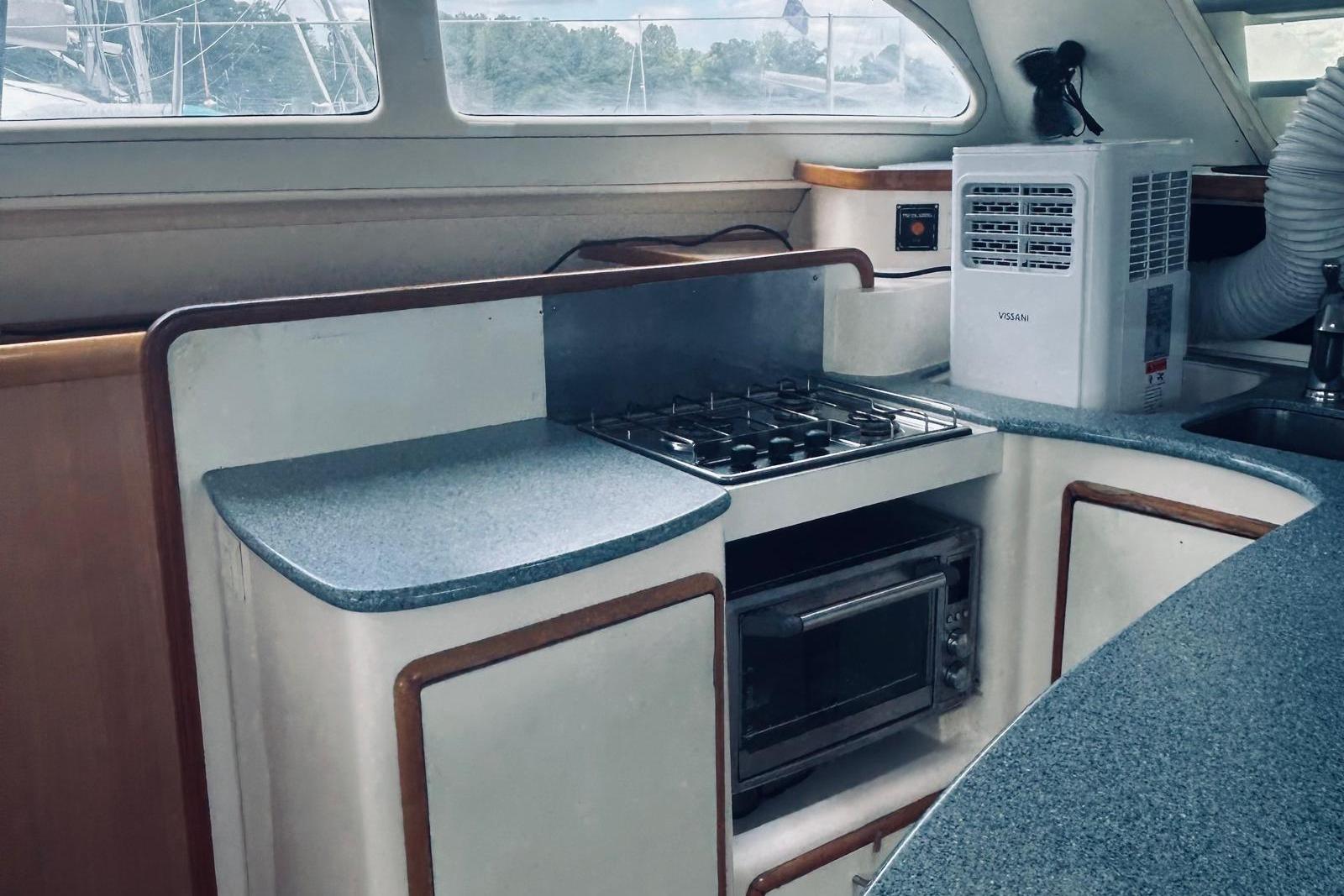 2001 Robertson & Caine Leopard yacht kitchen with stove, oven, and countertop.