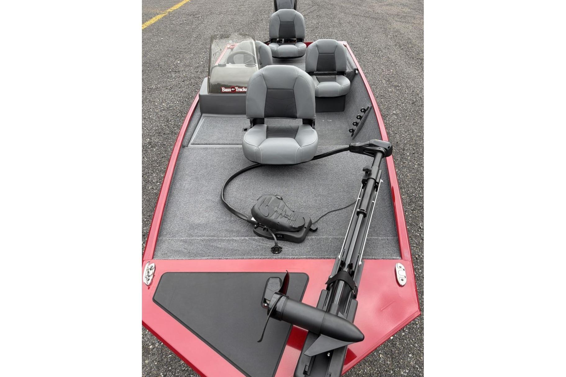 2026 Tracker Bass Tracker Classic XL boat with gray seats and red trim on asphalt.